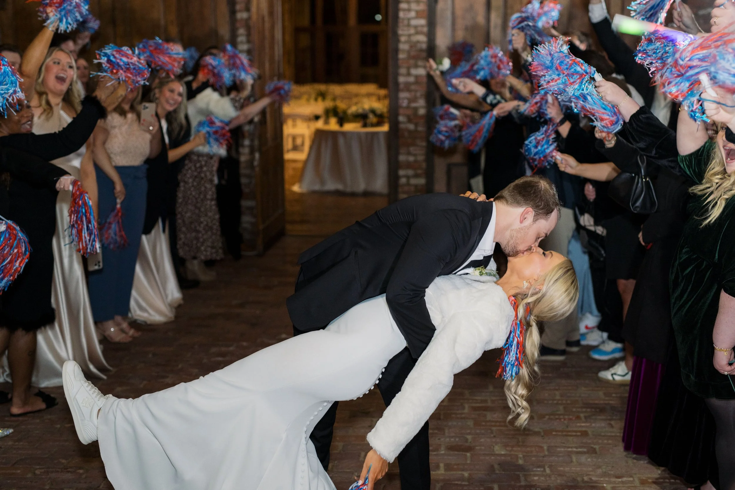 couple kissing pom pom wedding send-off at The Jefferson Oxford