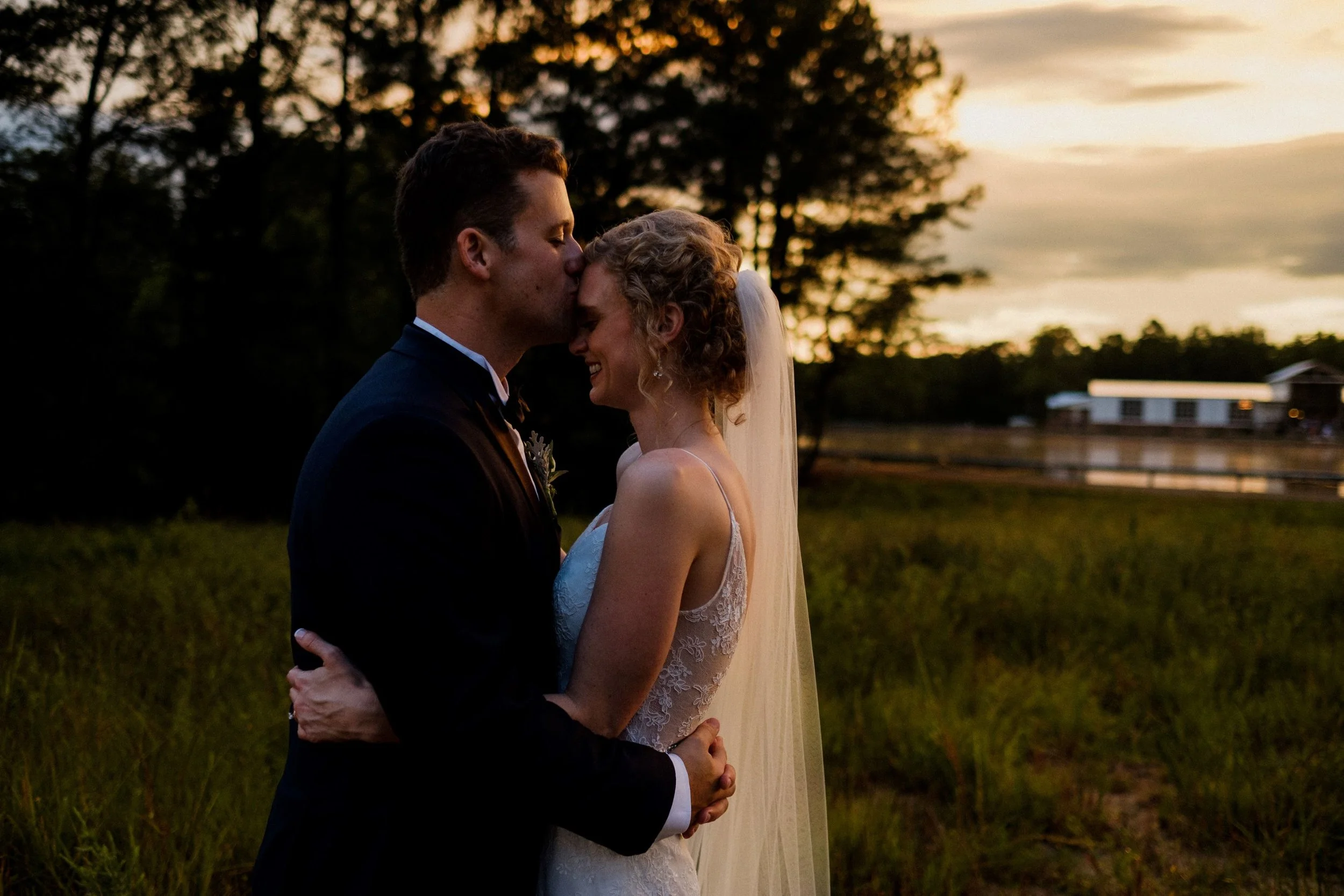 golden hour couple with lake and venue in background jefferson oxford ms