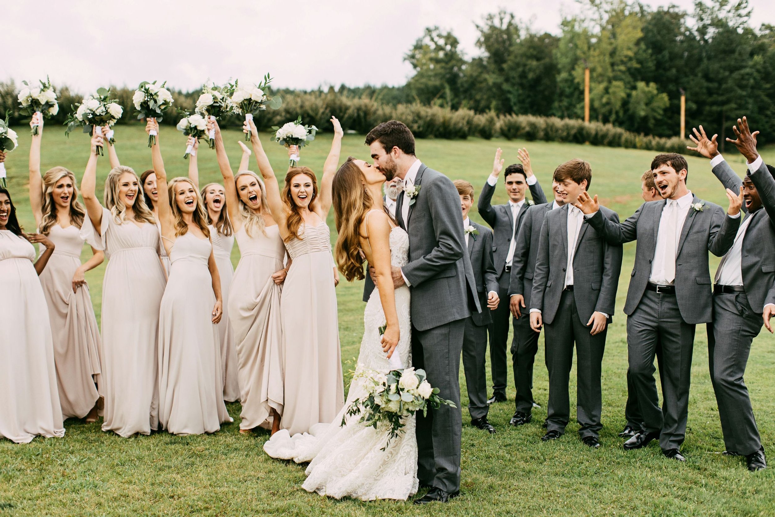 cheering bridal party as couple kisses outside at the jefferson oxford on wedding day