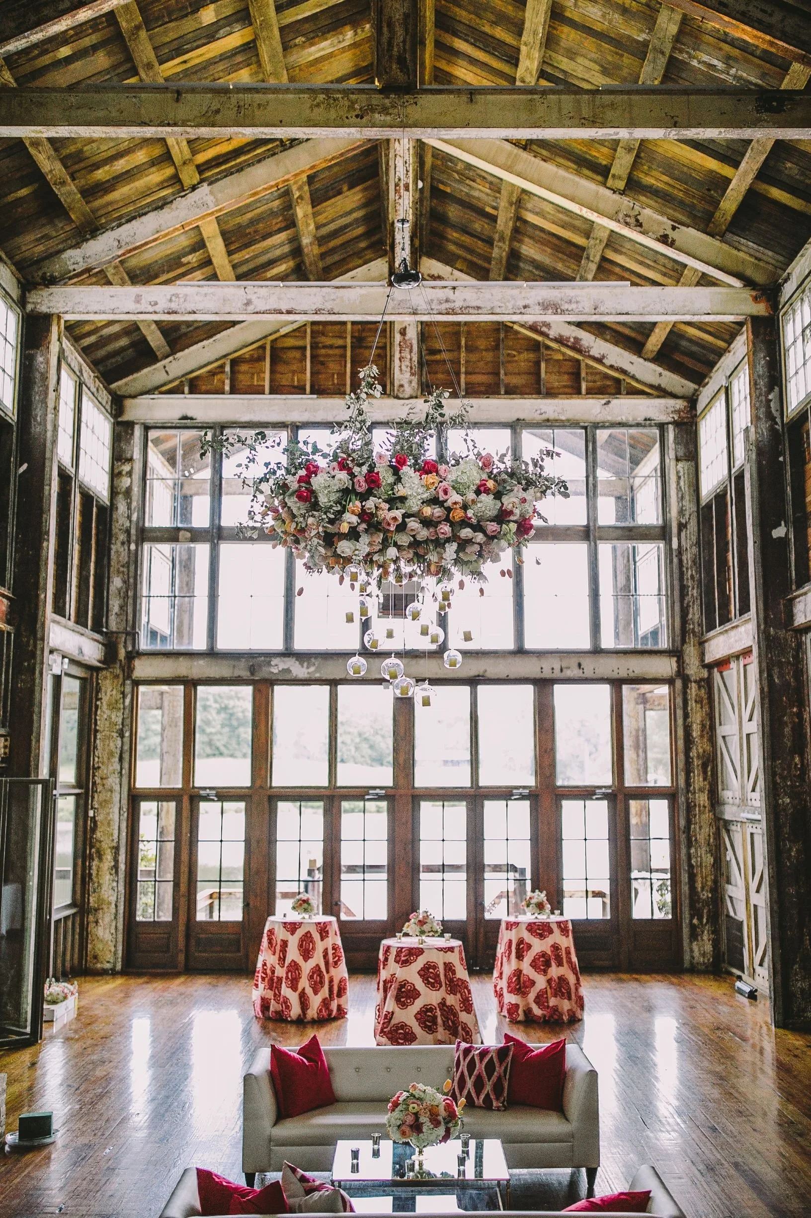 colorful floral chandelier hanging in faulkner room above soft seating at the jefferson oxford