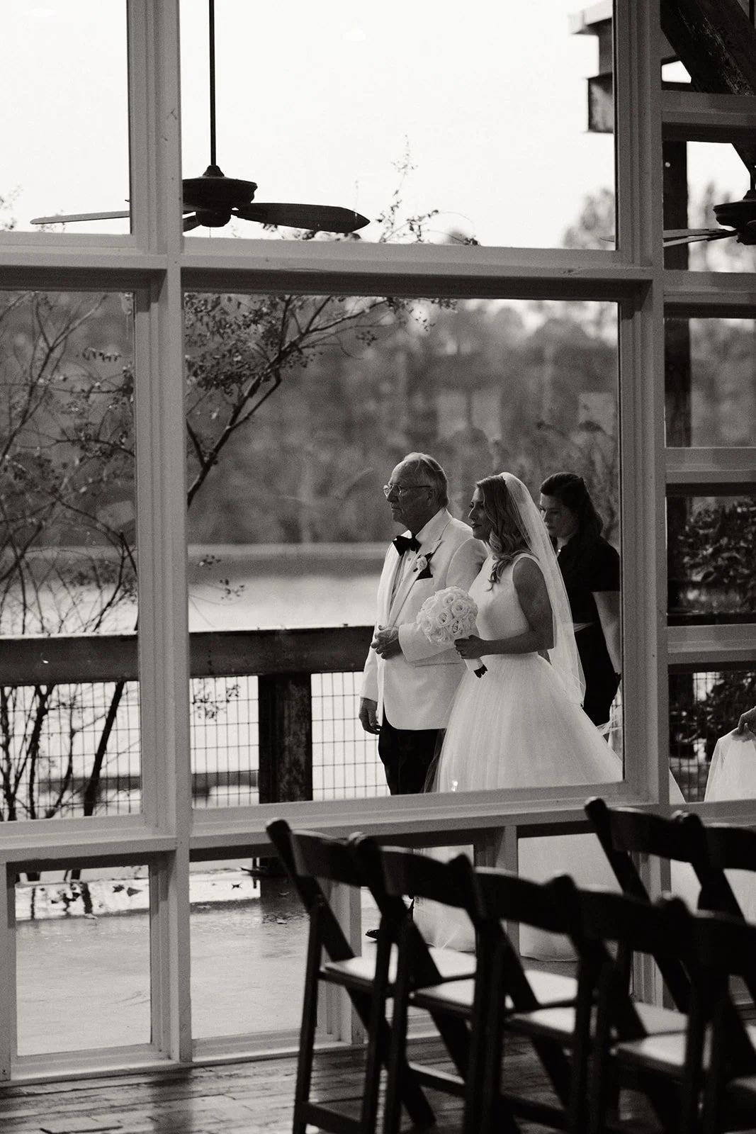 bride & father on covered porch walking towards ceremony in Lakeside Room at The Jefferson Oxford