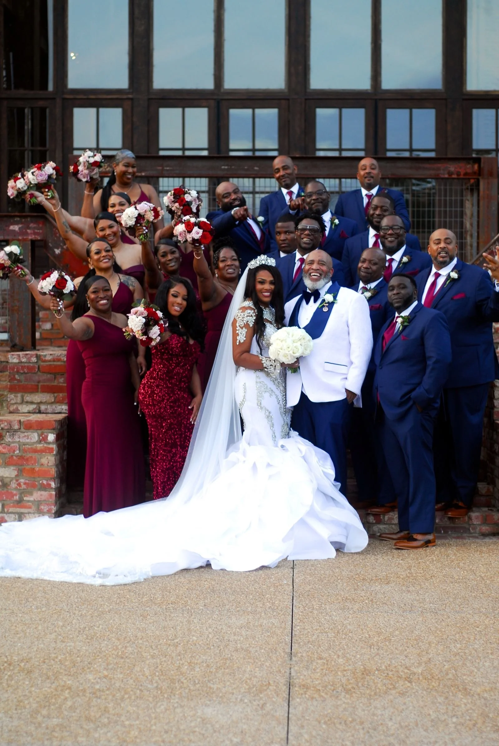 bride and groom with wedding party on lakefront stairway at the jefferson oxford ms