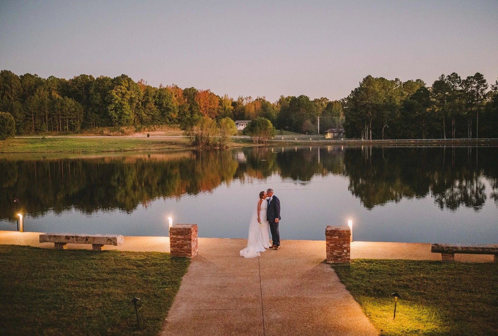 bride and groom on lakeside walkway wedding day at the jefferson oxford