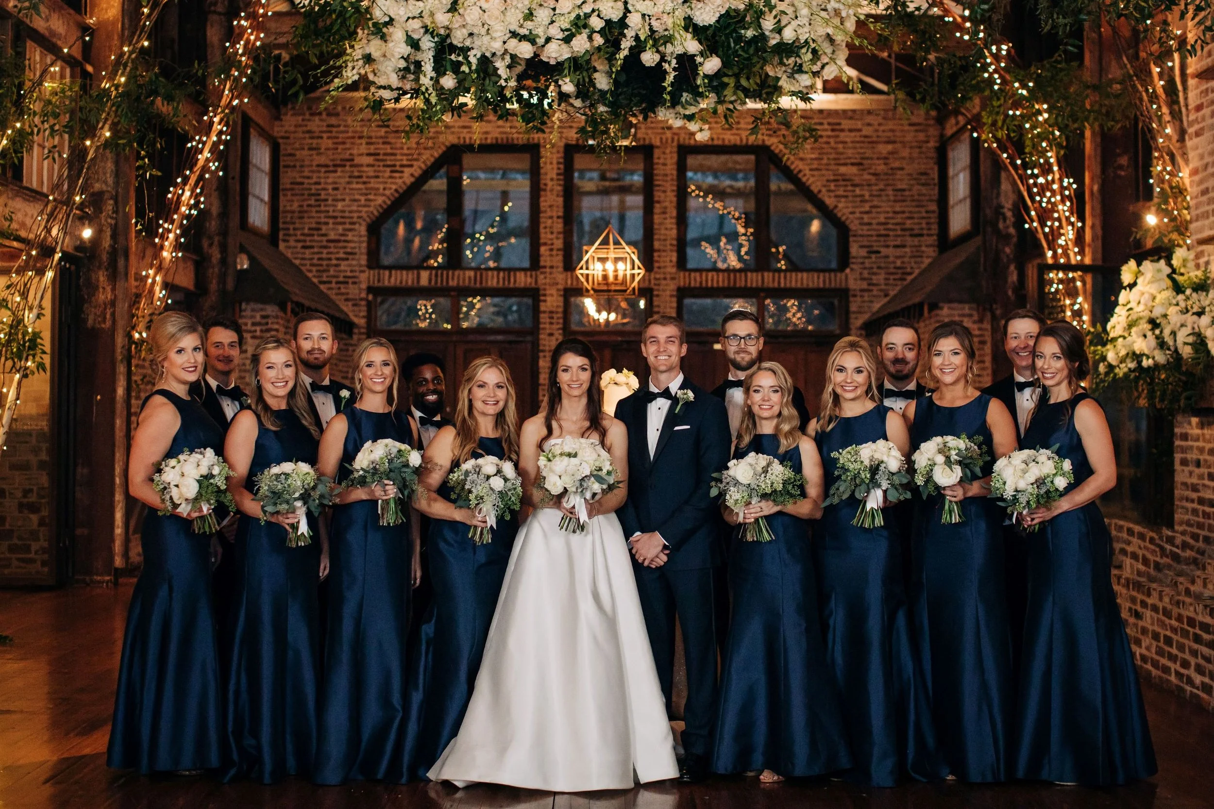 wedding bridal party under floral chandelier in faulkner room at the jefferson oxford MS