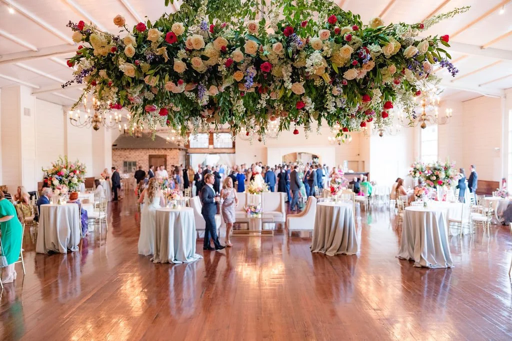 colorful floral chandelier hanging above dance floor in grand hall jefferson oxford wedding.jpg