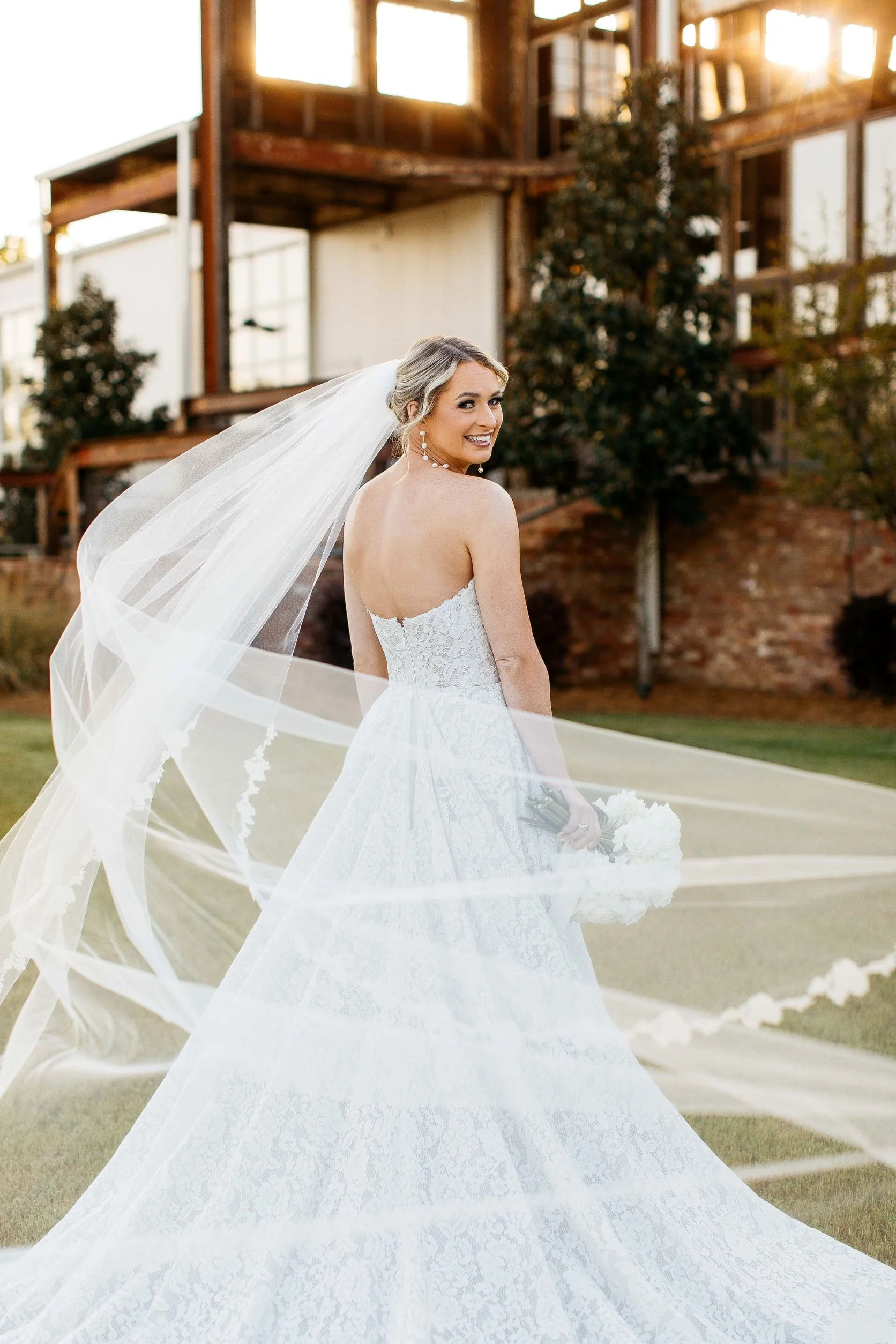 bride with swirling veil on lawn at Jefferson Oxford MS