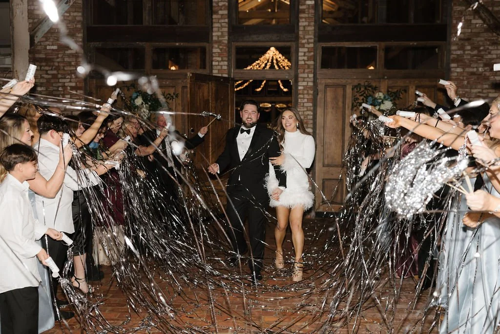 couple and guests at wedding send-off with streamers at the Jefferson oxford