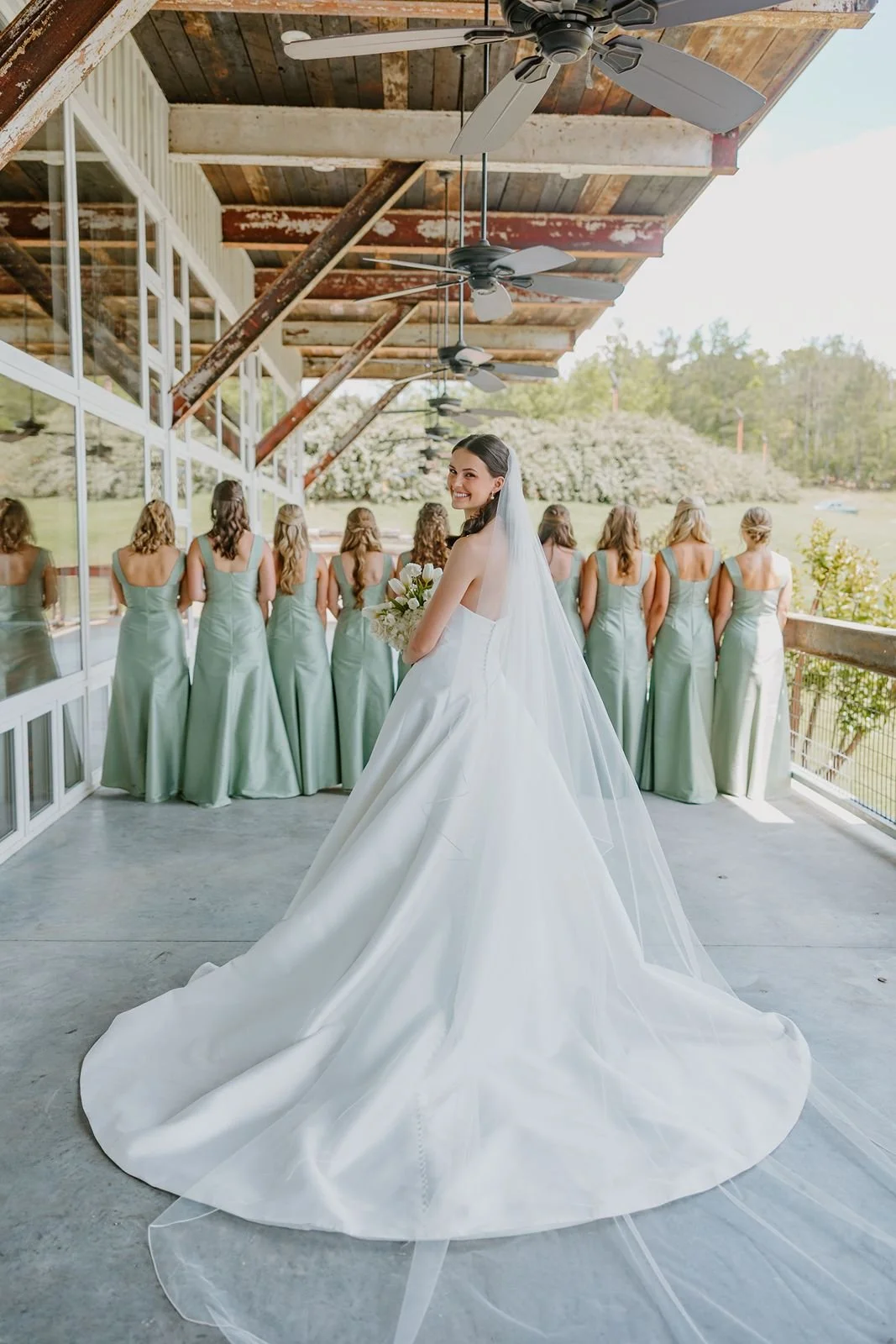 first look bride and bridesmaids on covered porch at The Jefferson Oxford