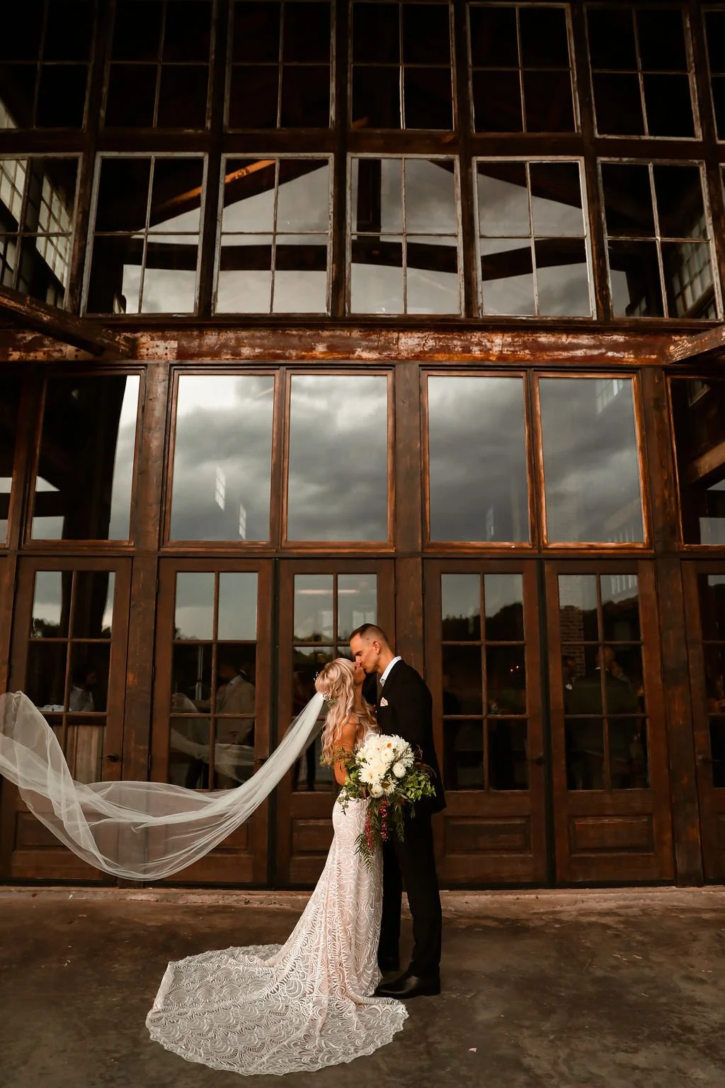 couple kissing on the covered porch on their wedding day at The Jefferson Oxford