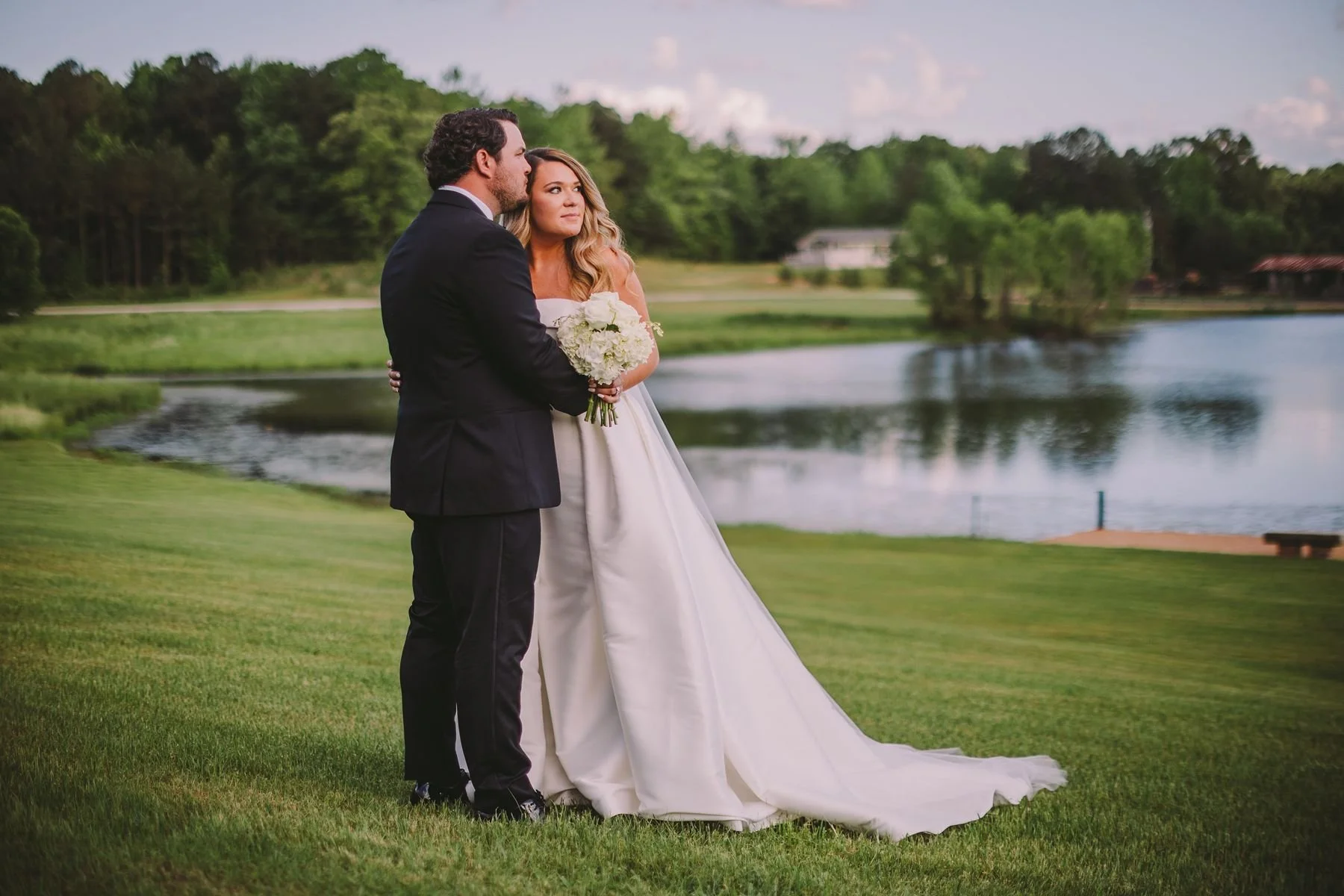 couple with lake in background on the grounds of Jefferson Oxford