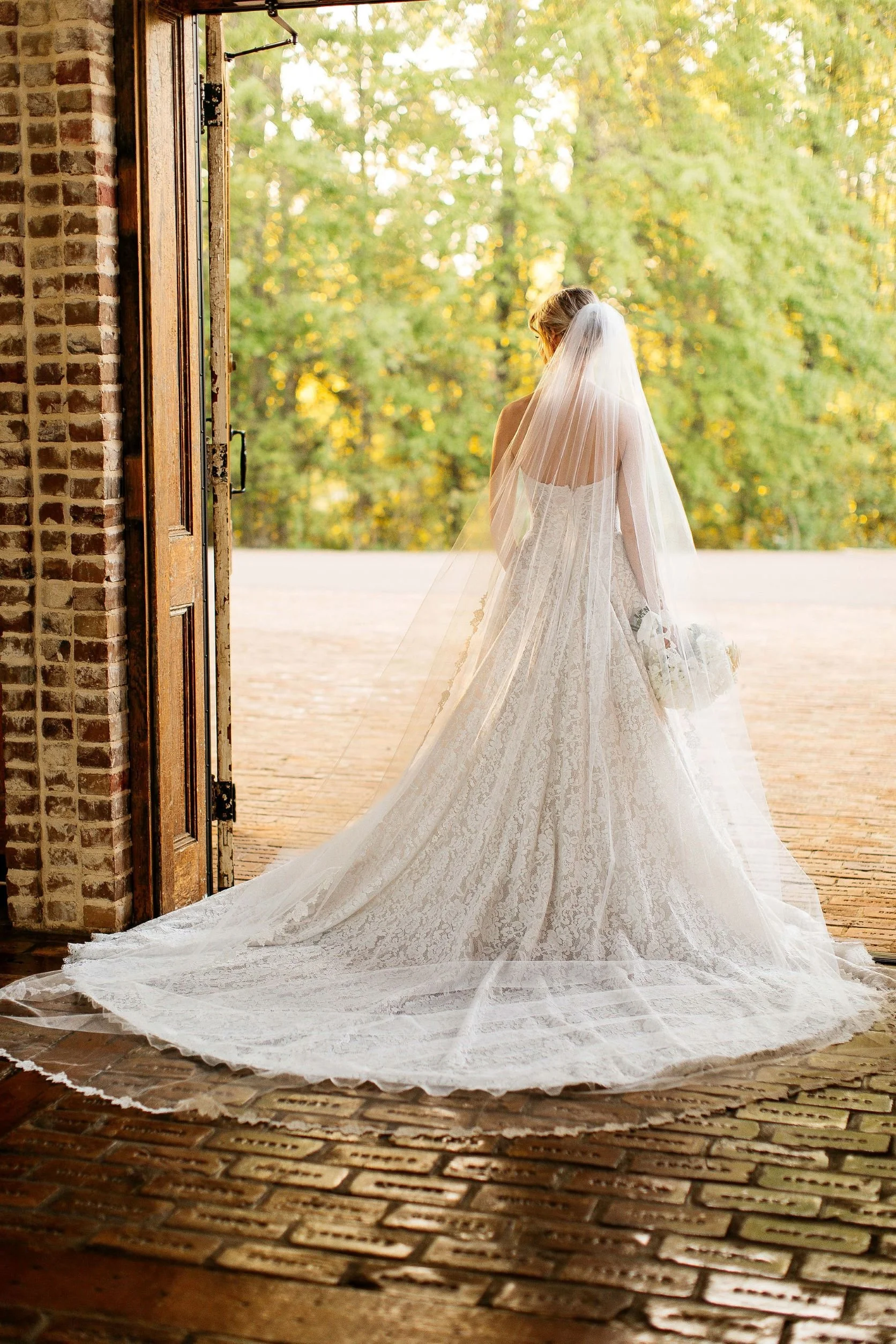 bride standing at open front door looking out at the jefferson oxford MS