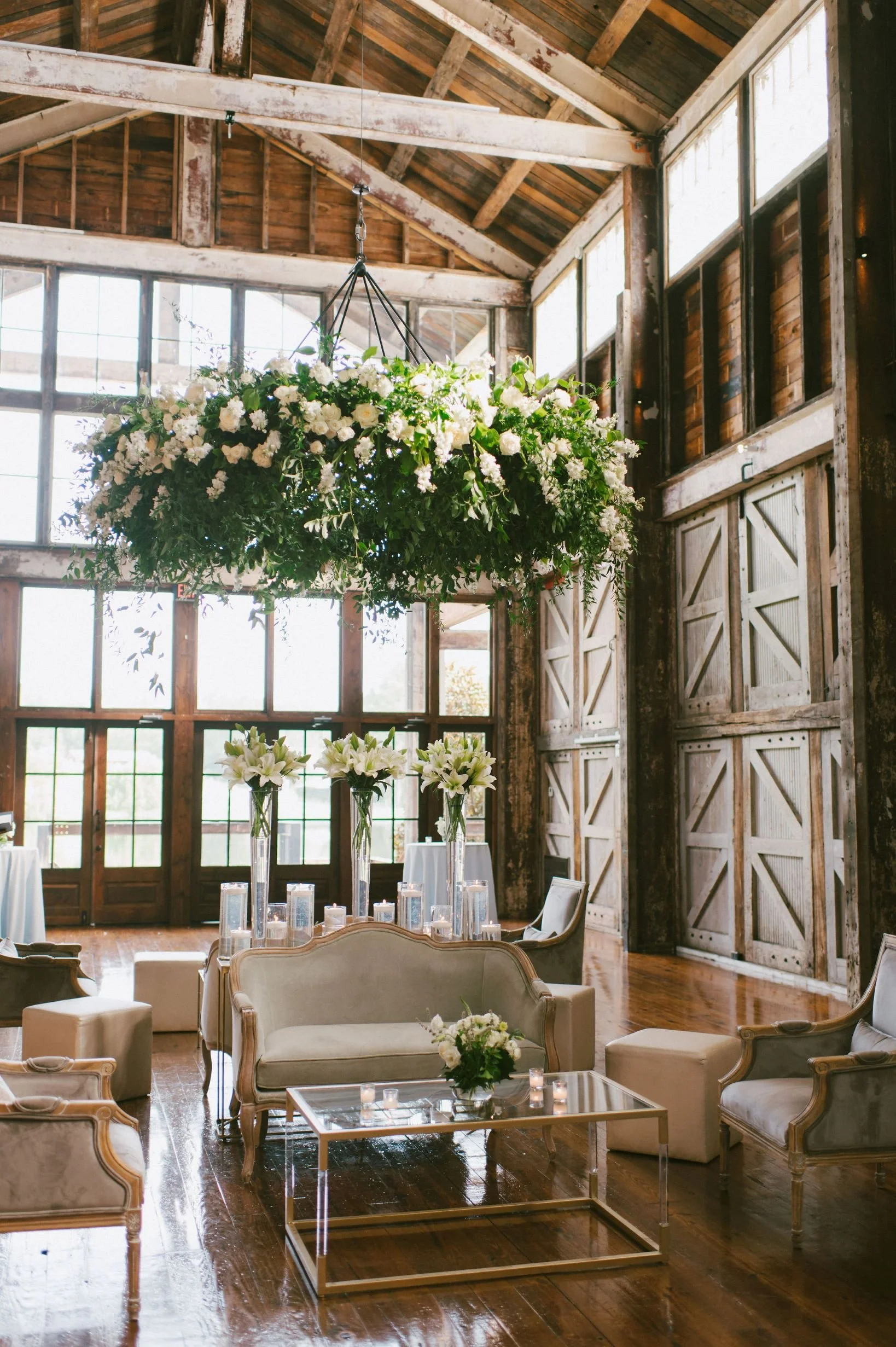 beautiful floral chandelier hanging in faulkner room over soft seating at the jefferson oxford