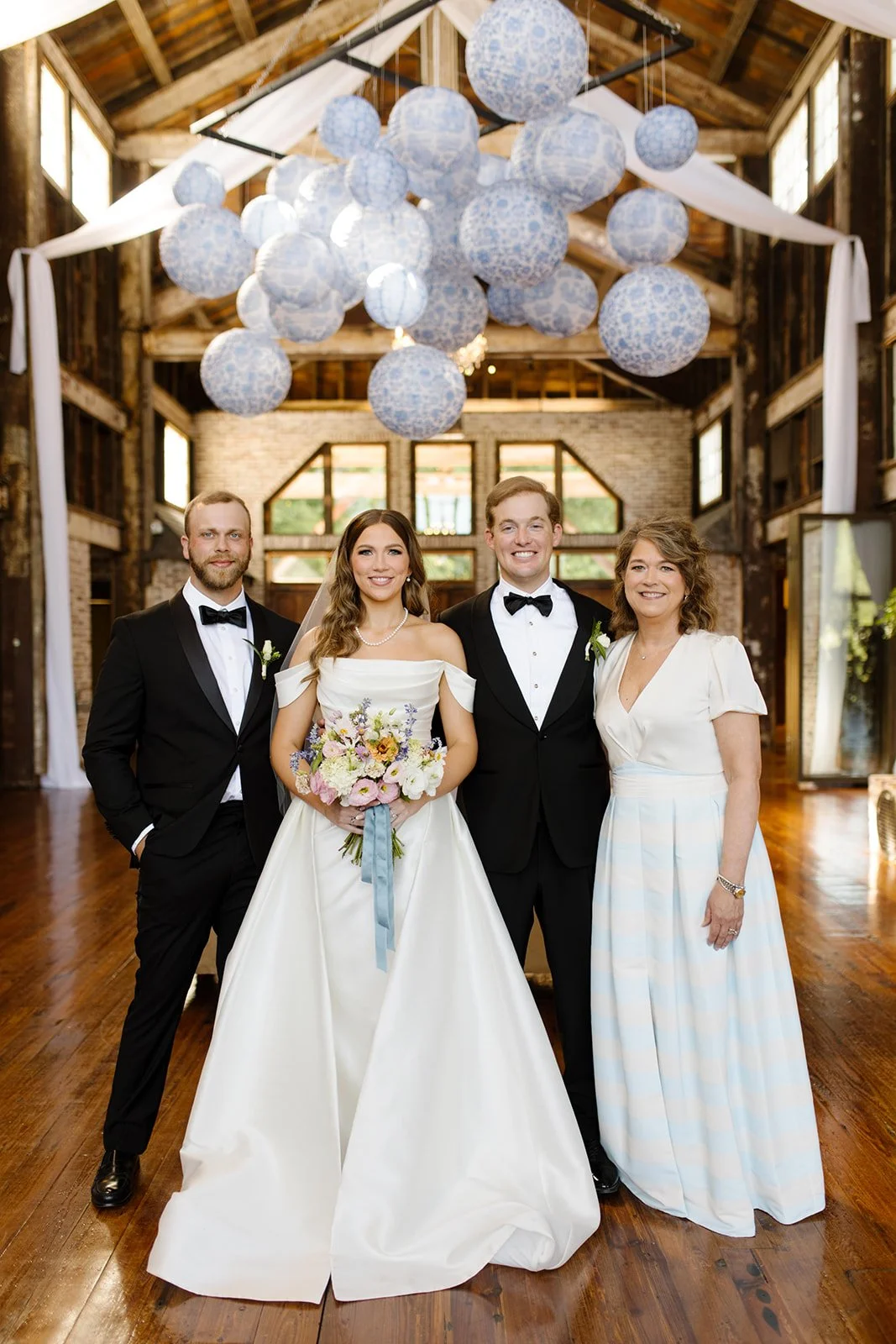Wedding couple under chandelier with paper balls at The Jefferson Oxford