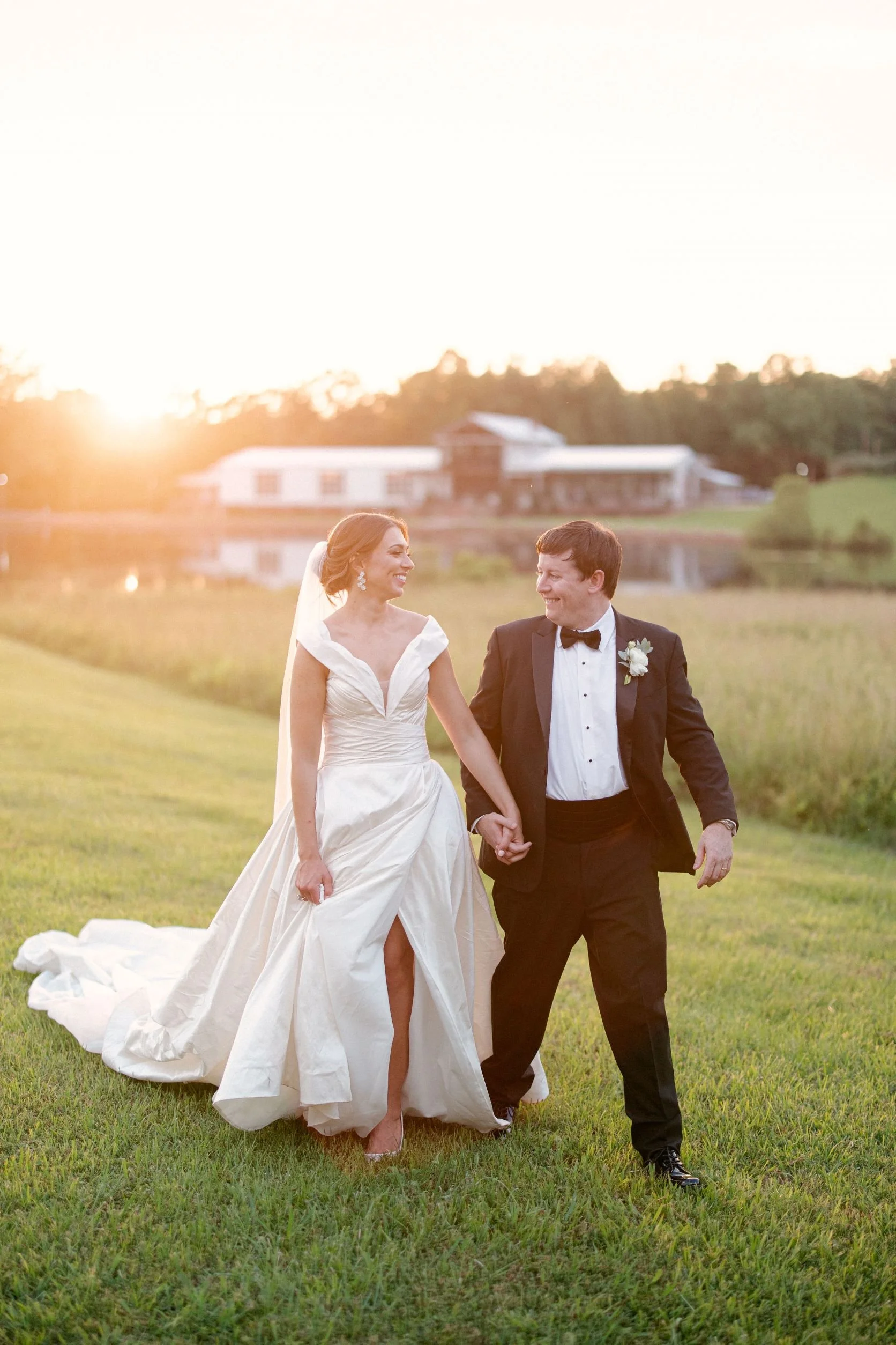 couple across lake with venue in background at jefferson oxford ms