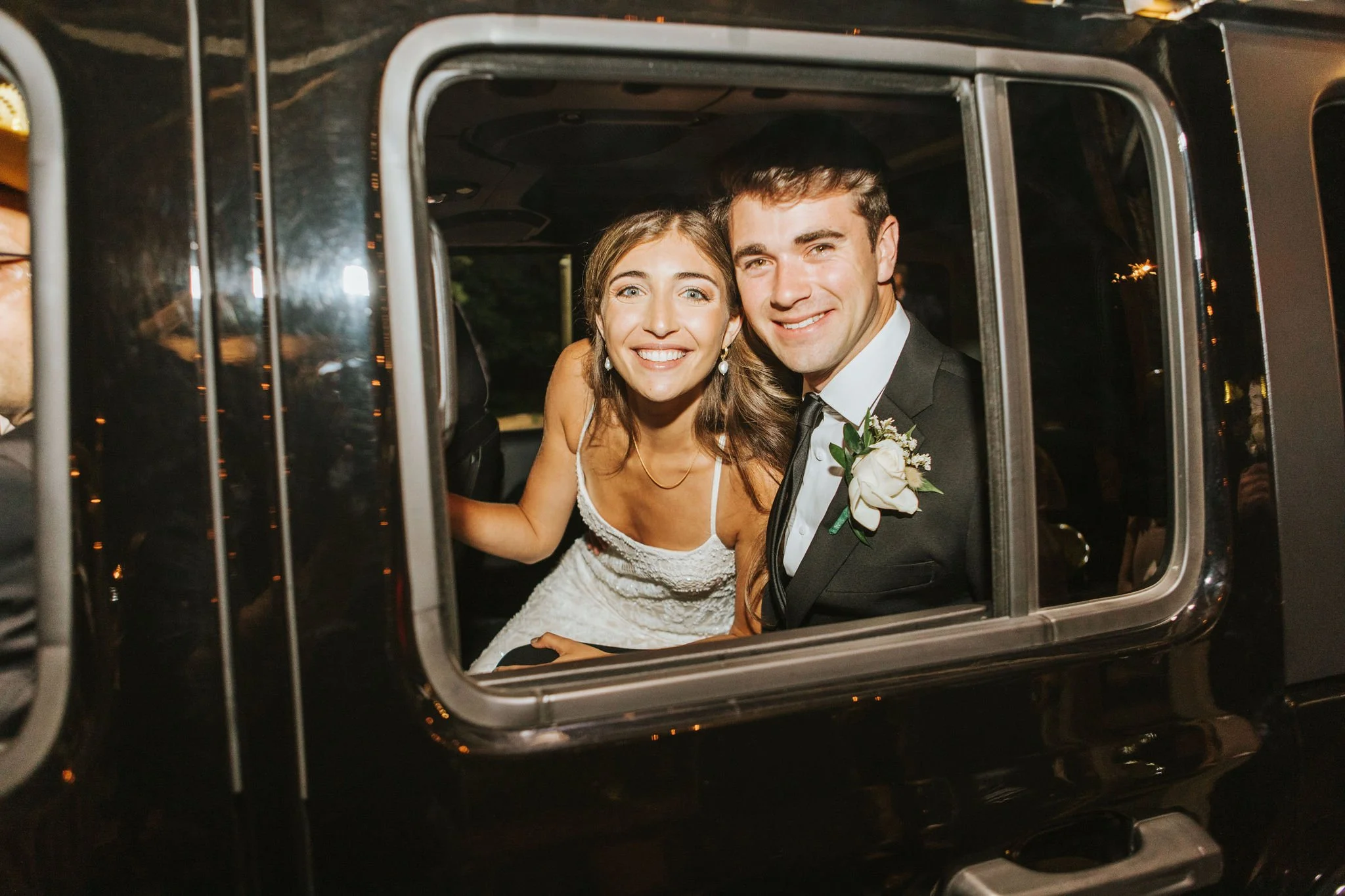 smiling bride and groom inside getaway car wedding send-off at the jefferson Oxford