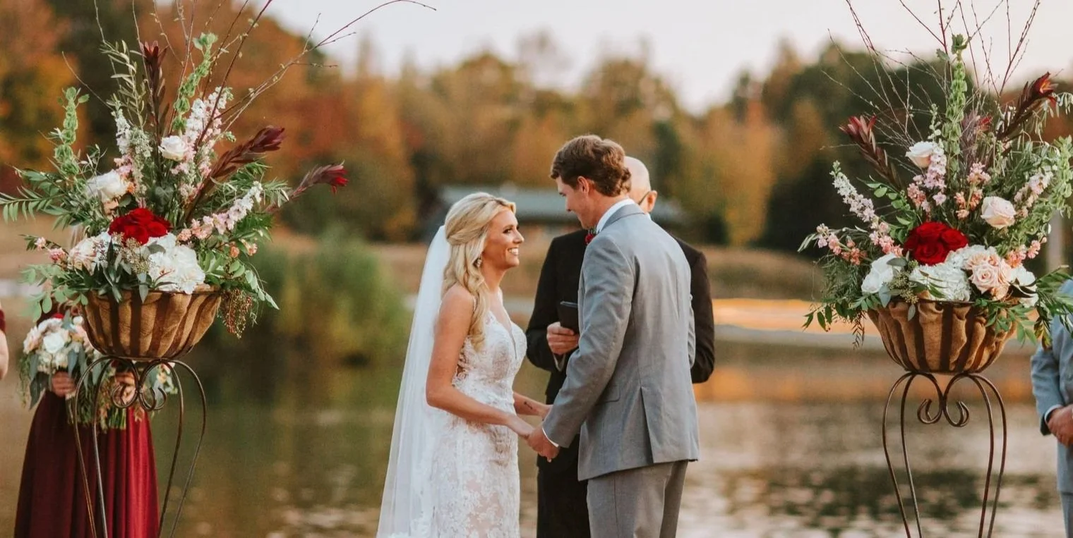 outside fall wedding ceremony on the lakefront walkway at the jefferson oxford ms