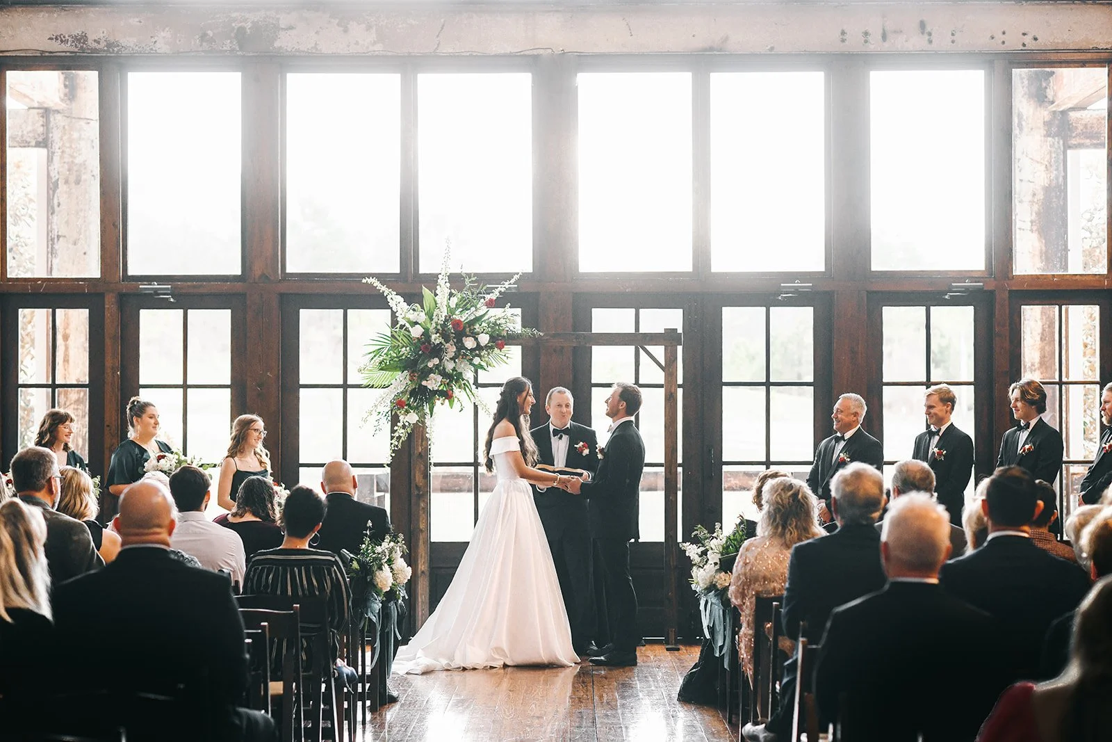 couple in Faulkner Room wedding ceremony with florals at Jefferson Oxford