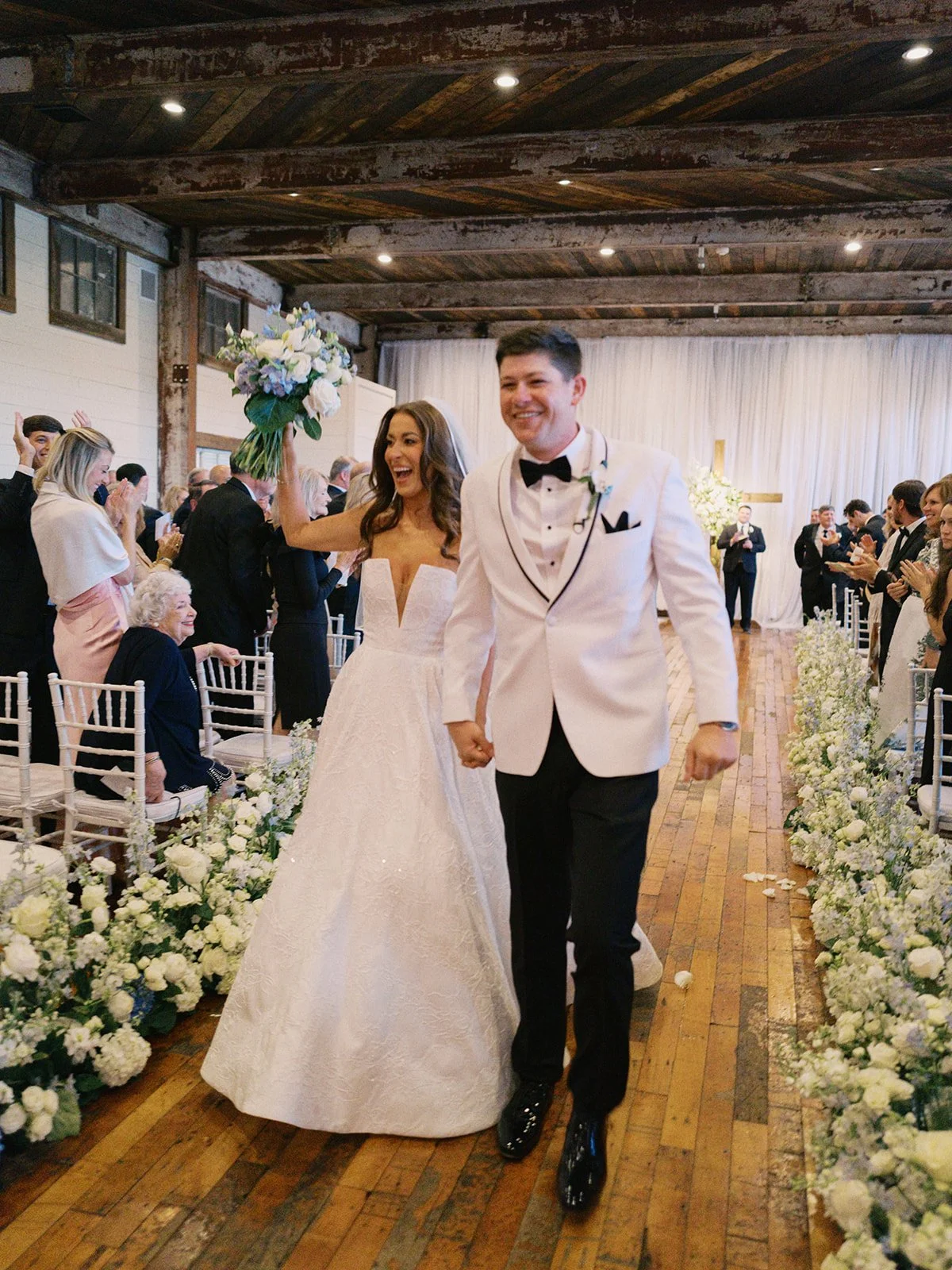 couple during a wedding ceremony recessional in the lakeside room at the Jefferson Oxford