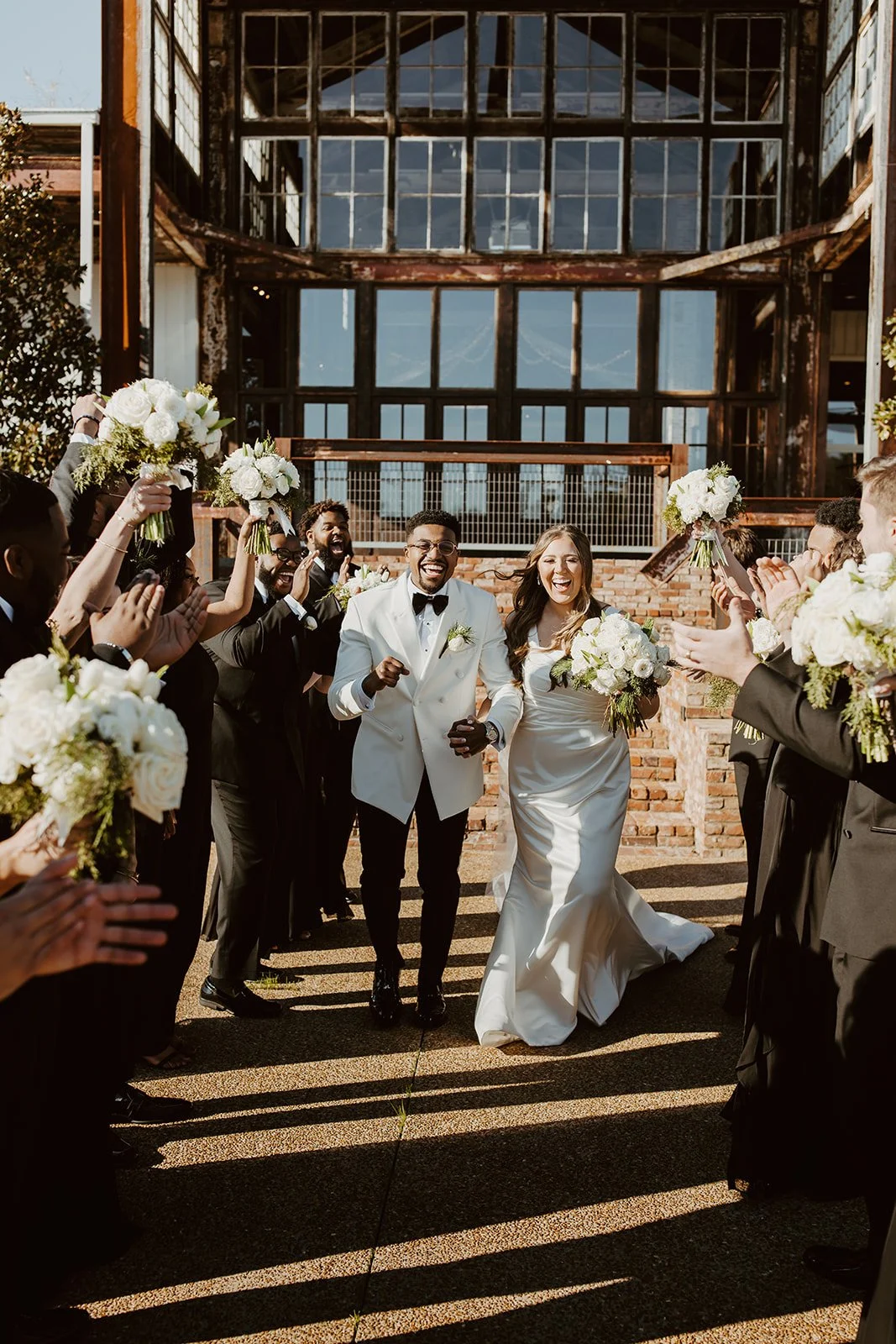 couple walking with bridal party on grounds of jefferson oxford m