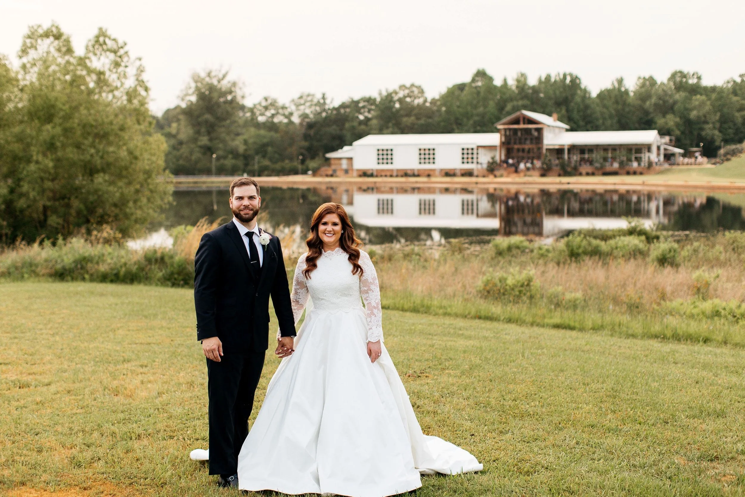 couple across lake with venue in background jefferson oxford MS