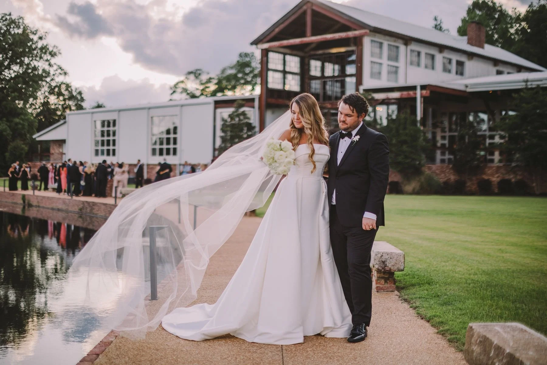 couple along lake with venue in background at Jefferson Oxford