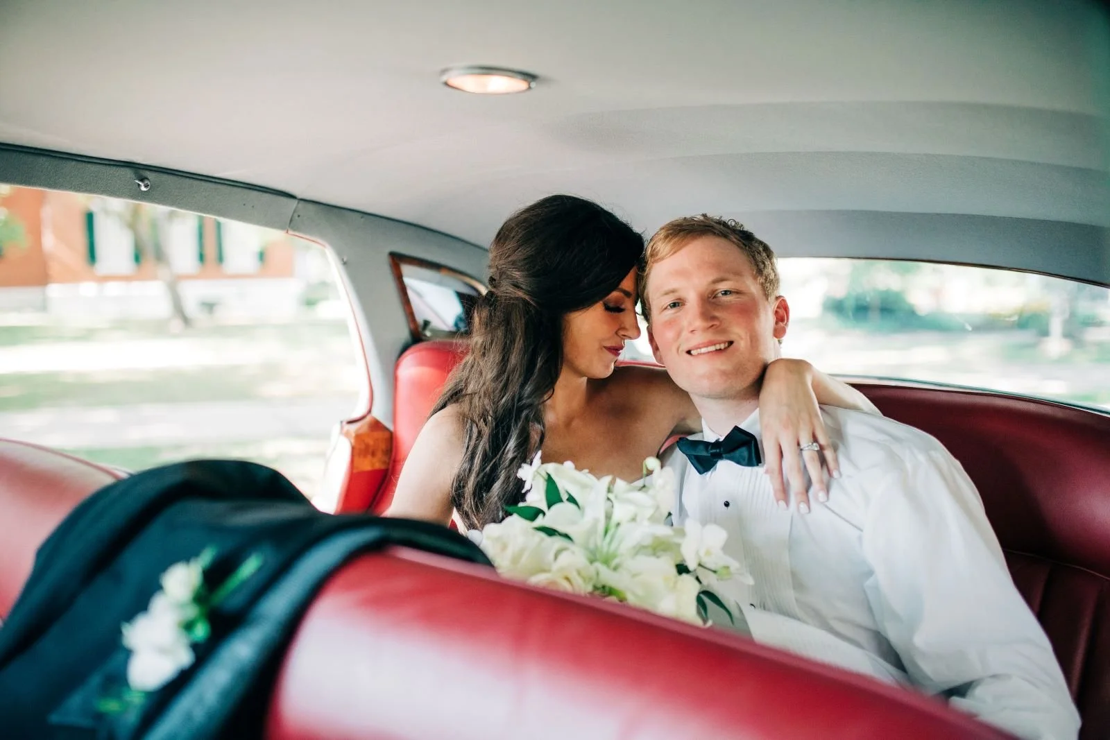 bride and groom inside getaway car wedding send-off at the jefferson Oxford