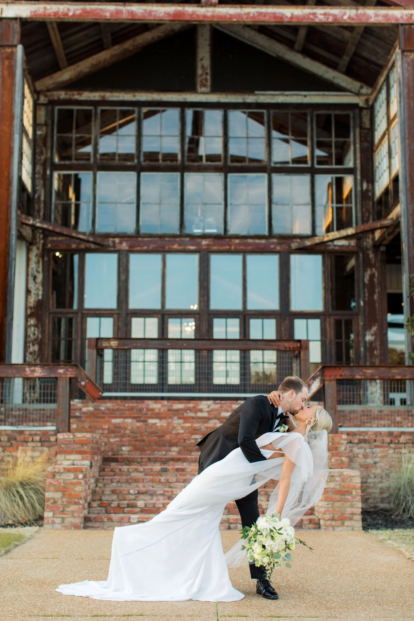 bride and groom kissing on lakefront stairway jefferson oxford ms