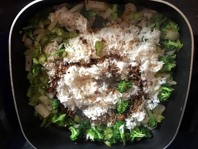 Make a well in the veg when it's par-cooked, add a bit more sesame oil and add the rice. Let the rice fry for 1-2 mins, it starts to smell nutty and delicious. Pour the hoisin/soy mixture and incorporate the veg. Add sugar and fish sauce, cook an additional 1-2 minutes.