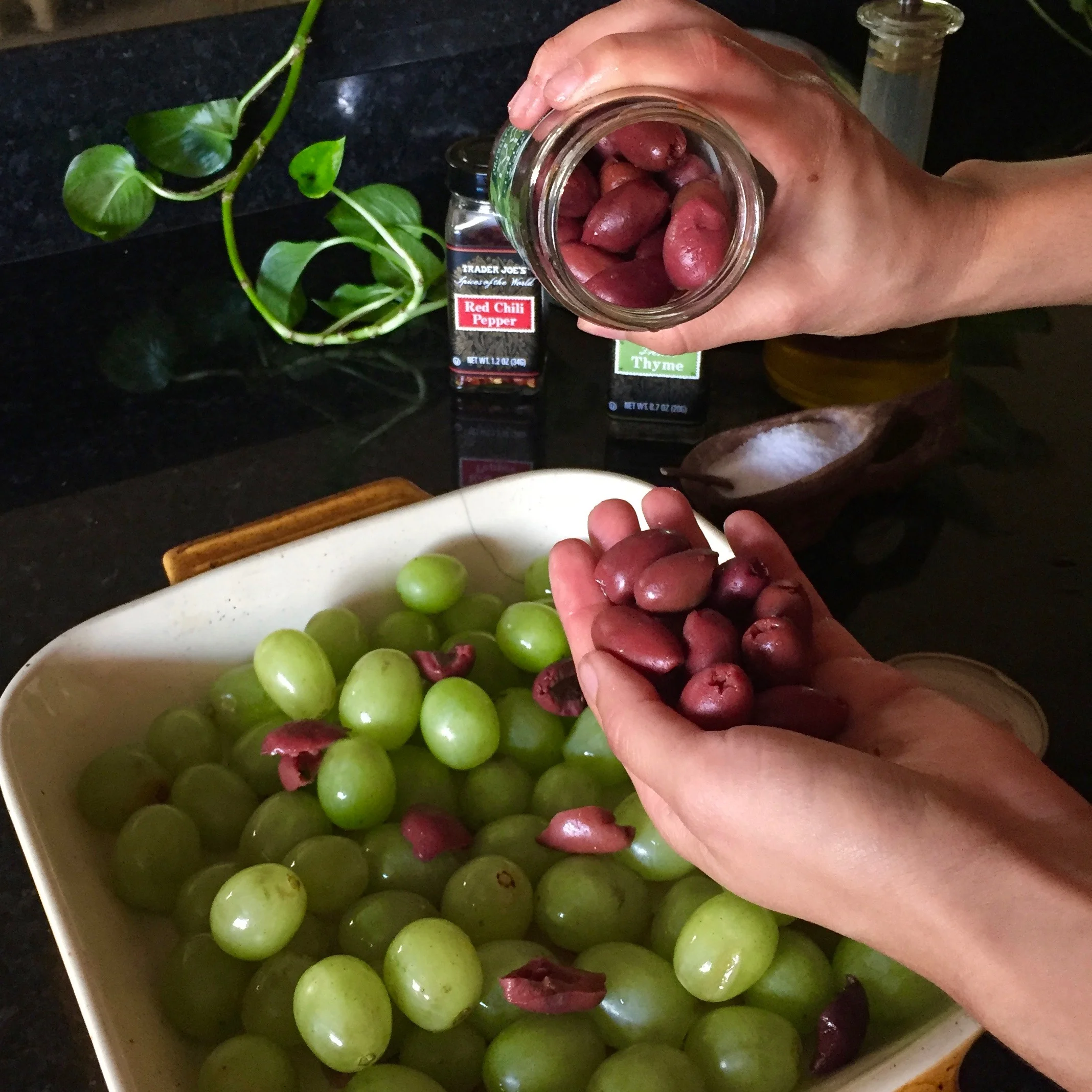 Drain olive brine, tear olives in half. I like a 1:2 ratio, olives to grapes. 