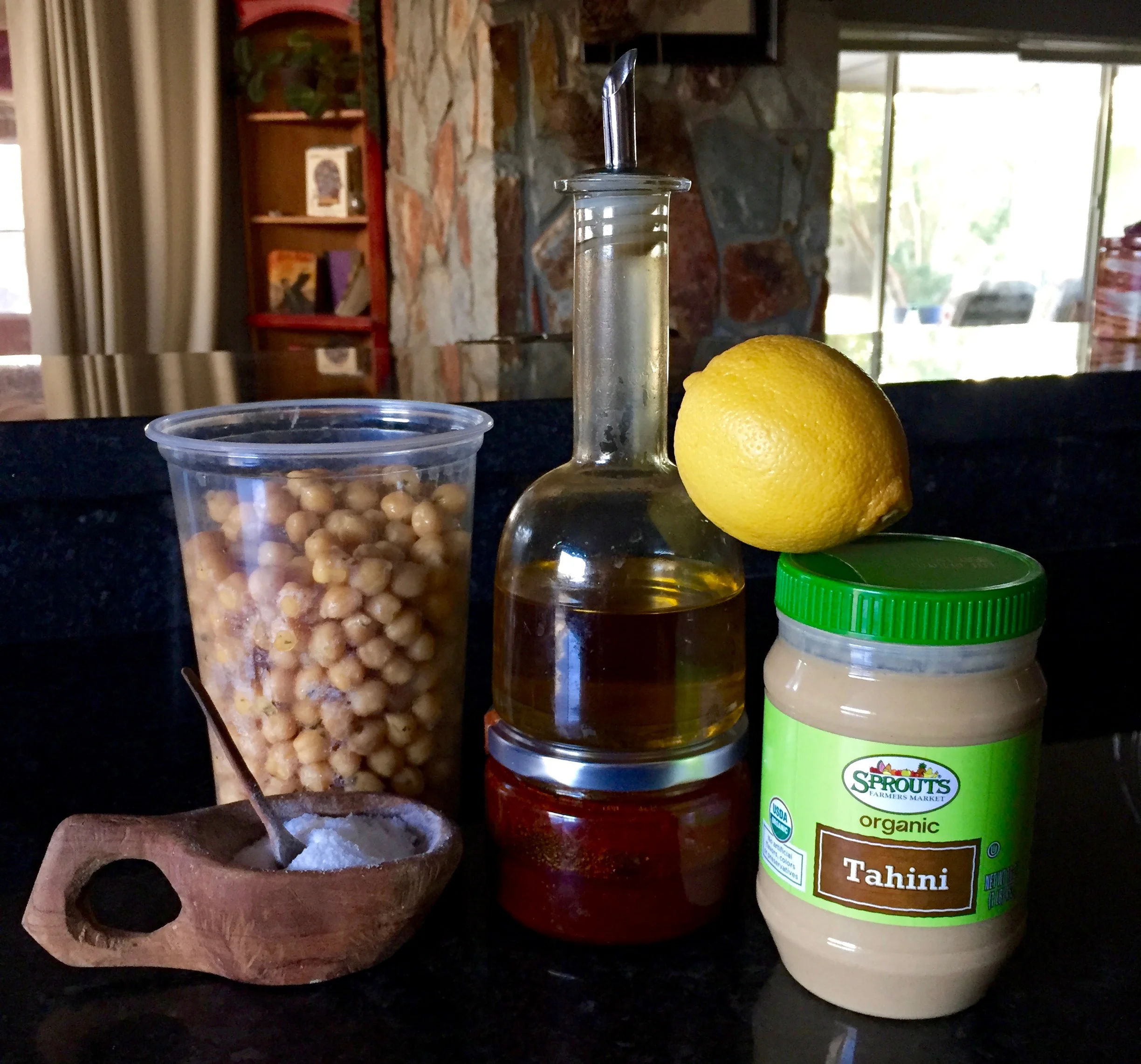 Cooked chickpeas, olive oil, lemon, tahini paste, harissa paste, salt