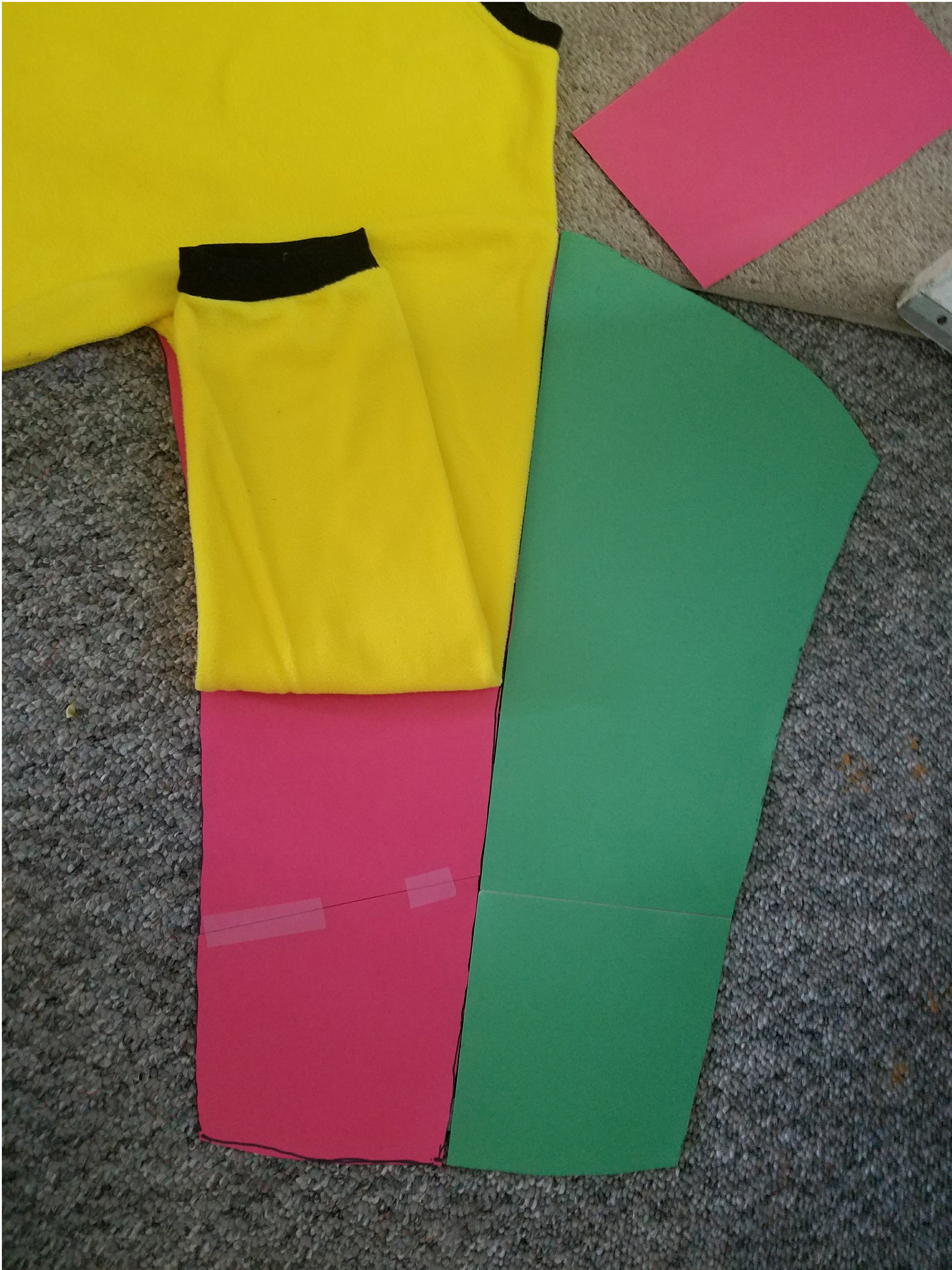 Start by using paper, tape, and a marker to create your fabric patterns. 