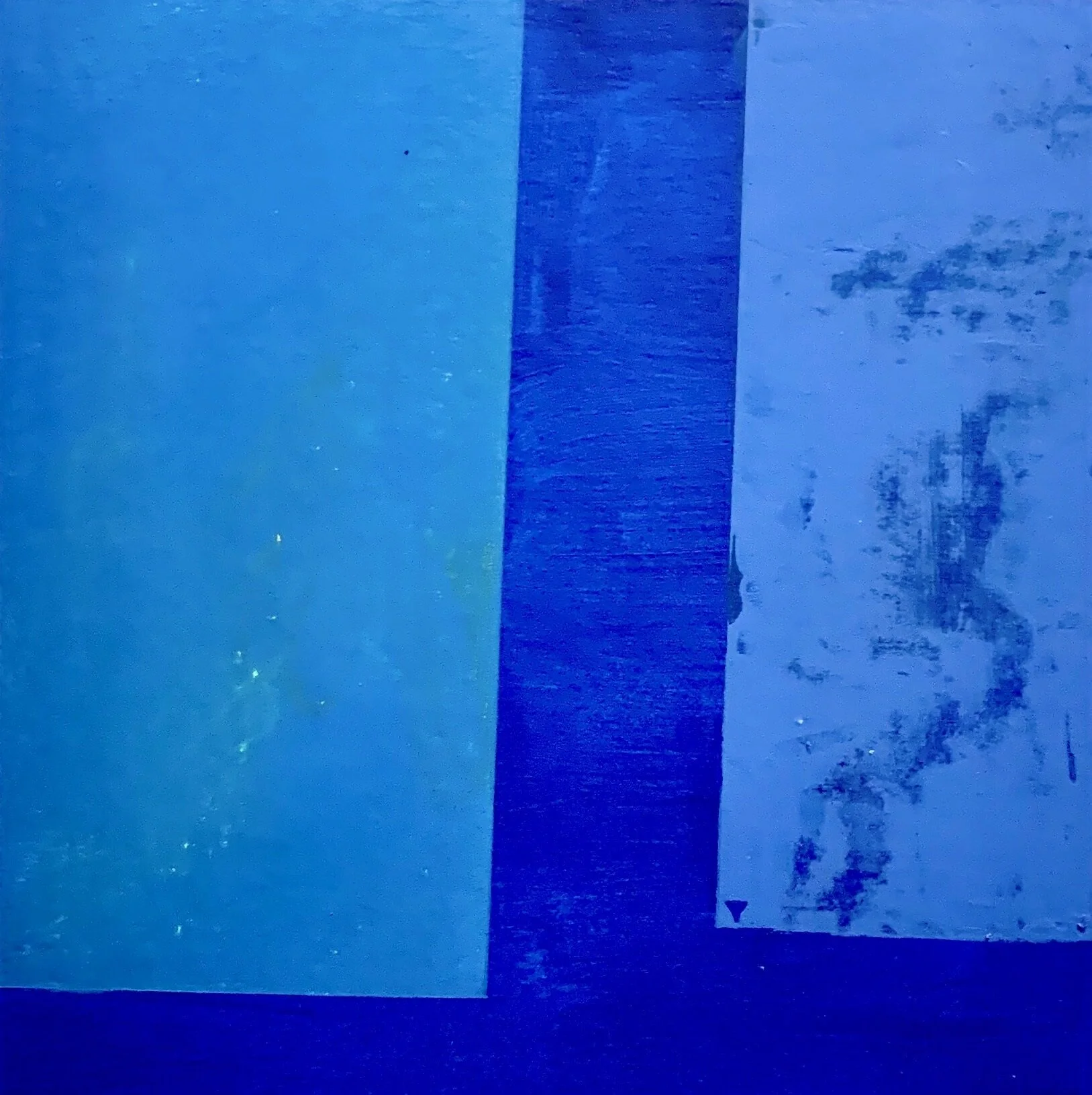 Close-up of a blue textured surface with faded areas and a darker vertical strip.