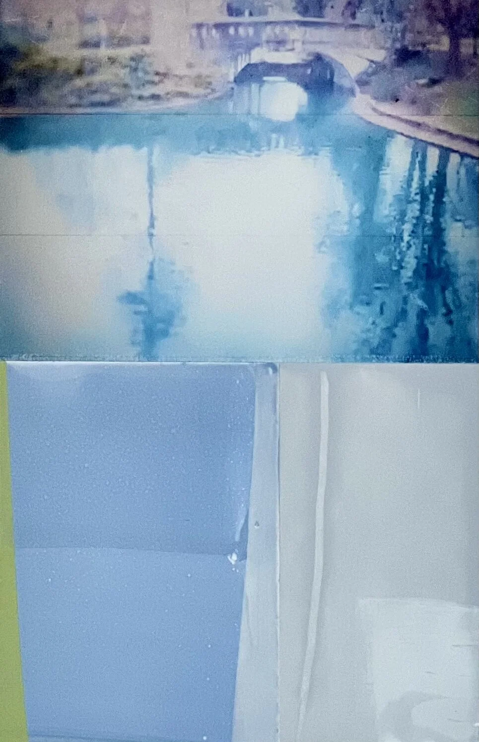 A river scene with a stone bridge and reflections of trees and the bridge on the water surface.