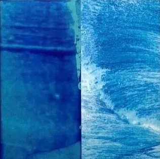 Close-up of an ocean wave with a blue sky in the background.