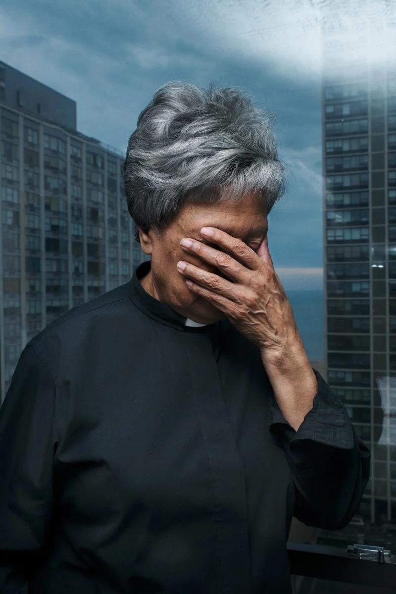 Rev. Alta Jacko in her priestly habit, praying in her apartment in Chicago, U.S. She was the first afro american woman to be ordained Roman Catholic Priest in history. Unlikely other Women Priests, Jacko is wearing a collar. The collar is seen as a symbol of power and is often replaced by a stole. (United States, 2013)