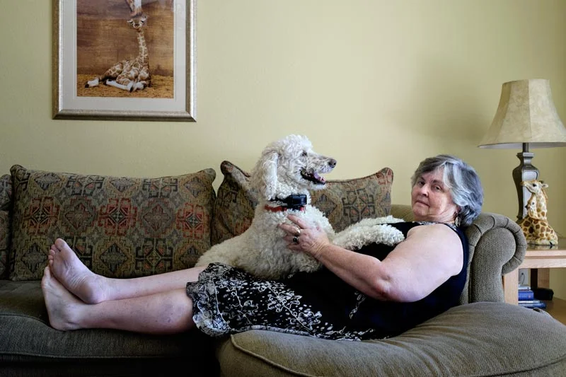 Rev. Dotty Shugrue plays with her dog Lilly in her home in Bonita Springs, Florida. She's now retired and lives with her partner Joanie. Both of them were former nuns of the Sisters of Notre Dame in Connecticut. (United States, 2015)