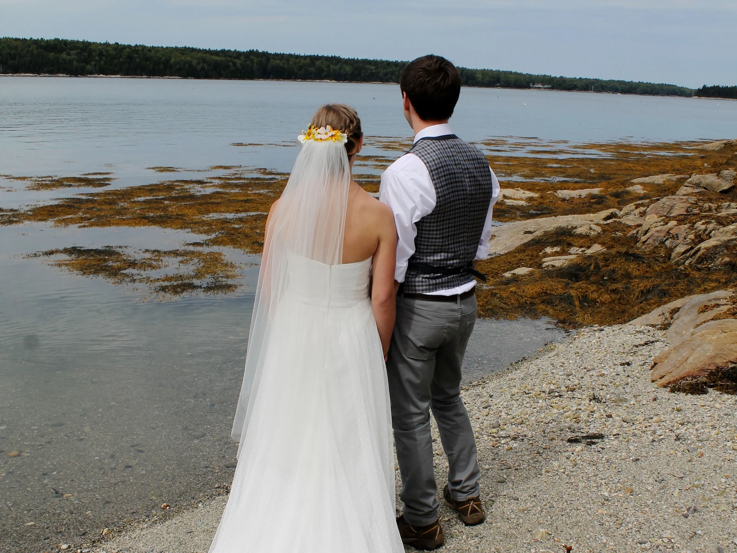 Couple Gazing at Ocean After Wedding