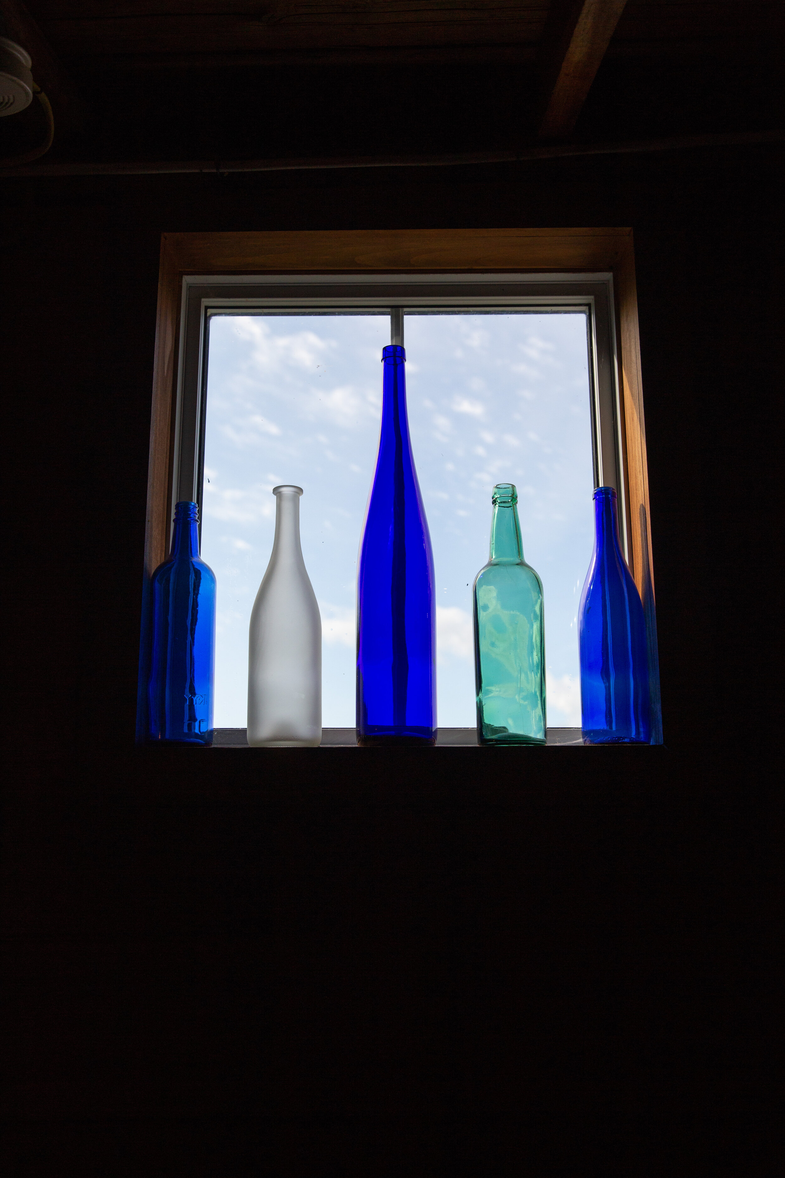 Barnacle Interior Colorful Bottles in Window.jpg