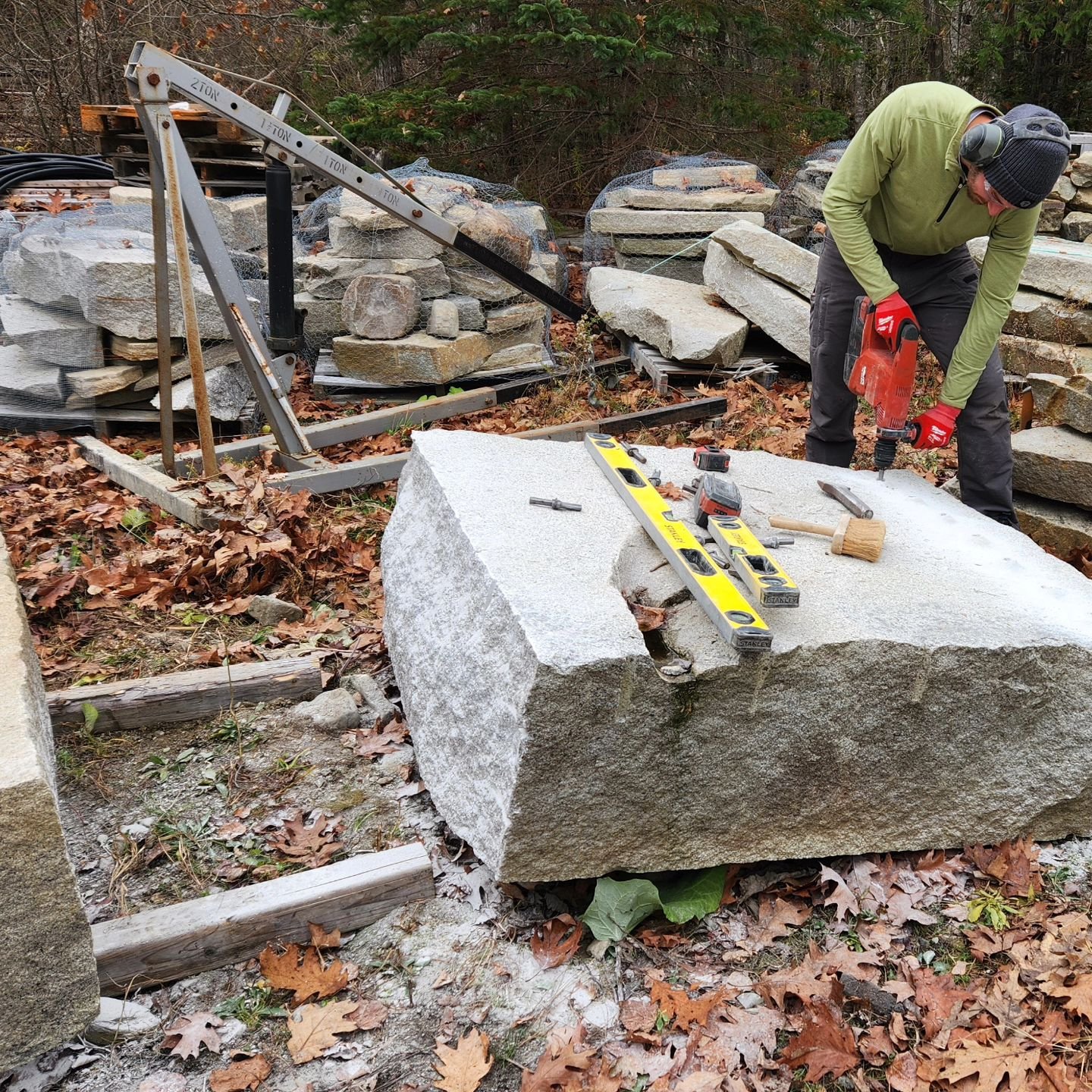 Joseph is splitting a large granite block to make steps for a new project.  #granite #stonesteps #customlandscapes #customstonework #stonemason #stonemasonsrock #mountdesertisland #acadia #maine @acadialandscape
