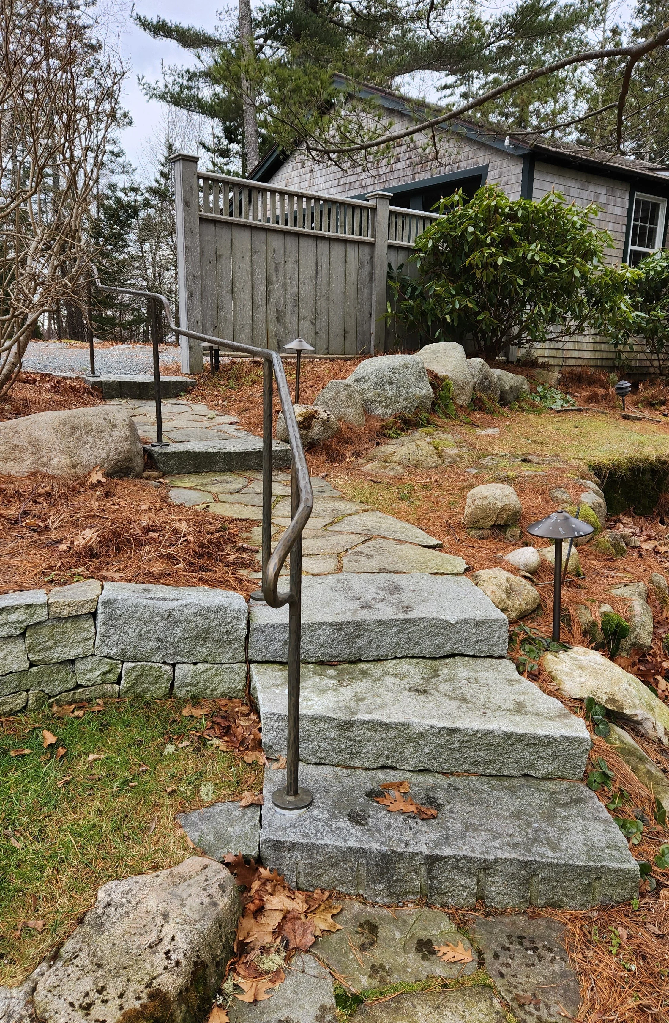 Stone walk with granite steps and custom iron handrail