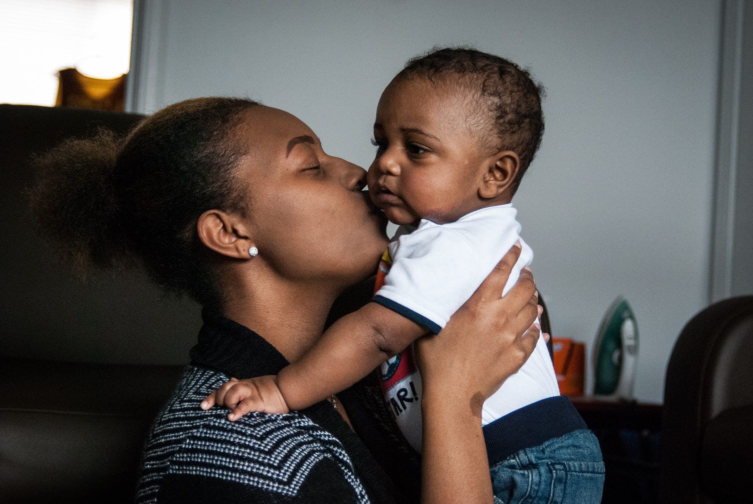Tiyana Shaw cuddles her son, Kenneth Conley III, at her apartment in Mount Pleasant, Mich. on April 15, 2015. Shaw plays double roles as a senior at Central Michigan University and a mother to "K3"