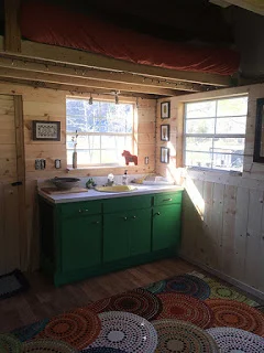 sleeping loft with linens and an empty second loft