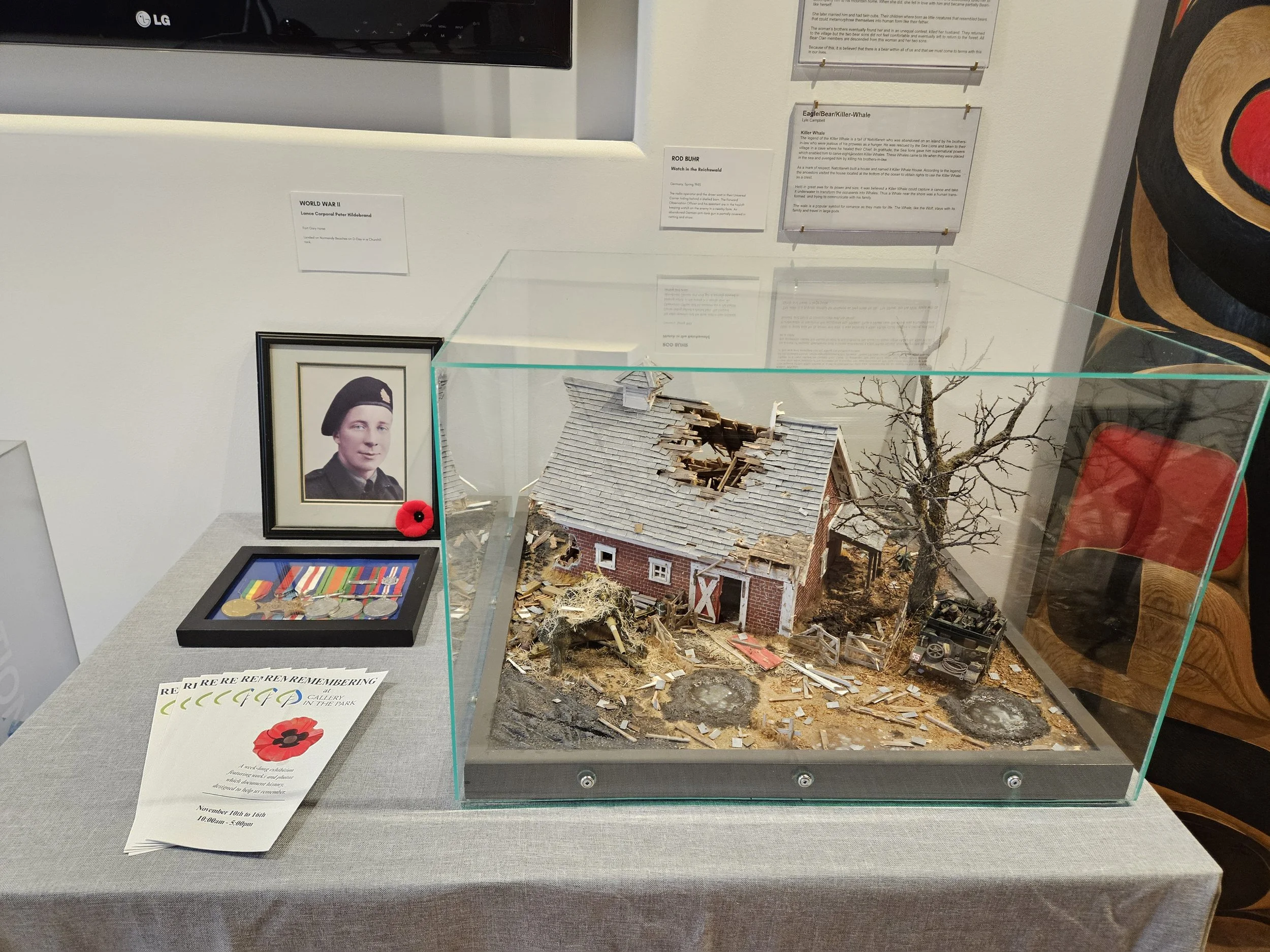  On display,  Watch in the Reichswald  by Rod Buhr depicts the radio operator and the driver waiting in their Universal Carrier hiding behind a shelled barn. The Forward Observation Officer and his assistant are in the hayloft keeping watch on the en