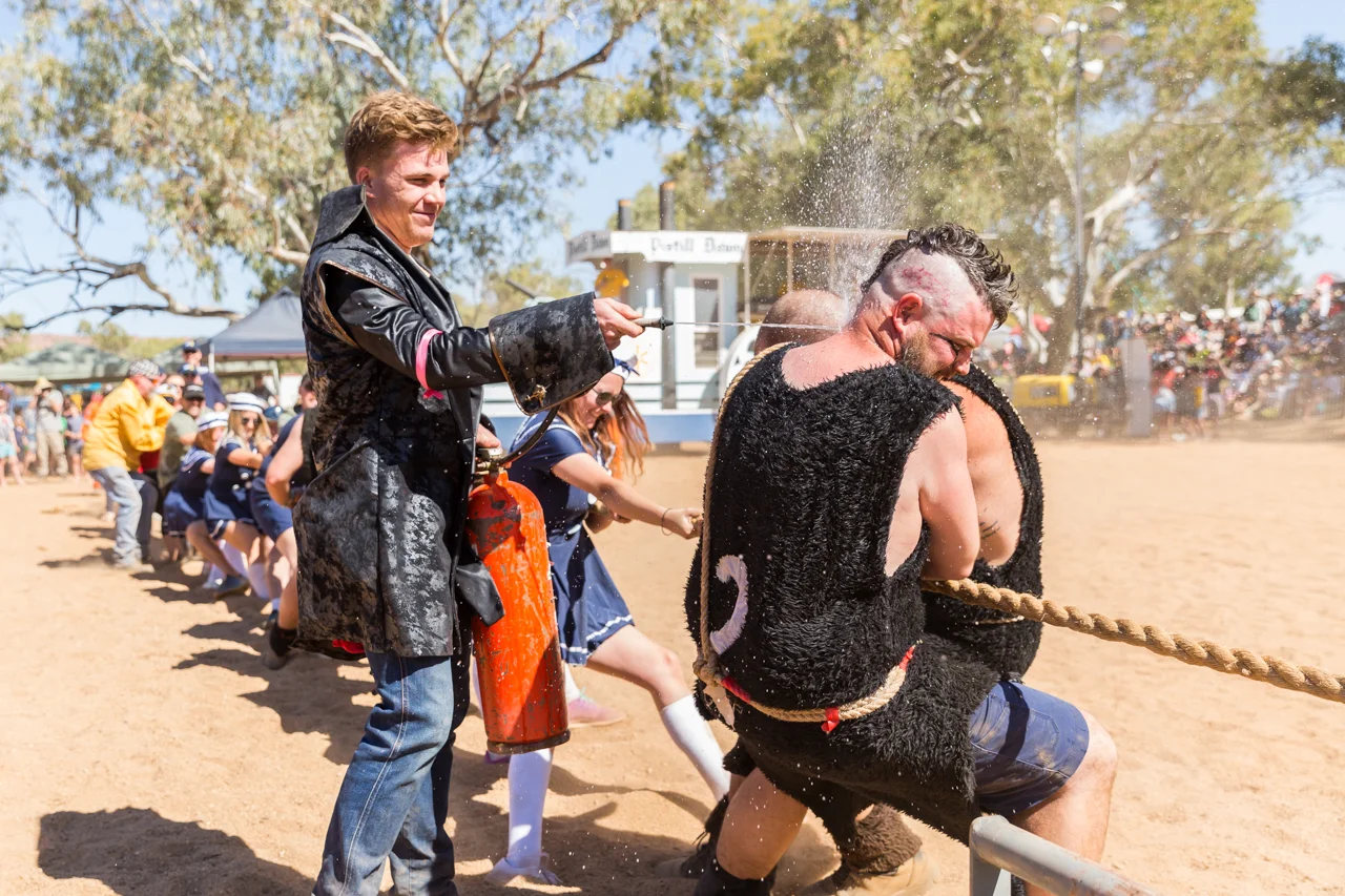Vikings jump in to help the Navy team in the tug of war competition while a pirate tries to distract them