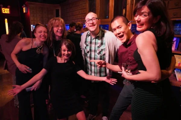 The Story Collider team poses with Josh after his story at our eighth-anniversary fundraiser! Photo by Carly Hoogendyk.