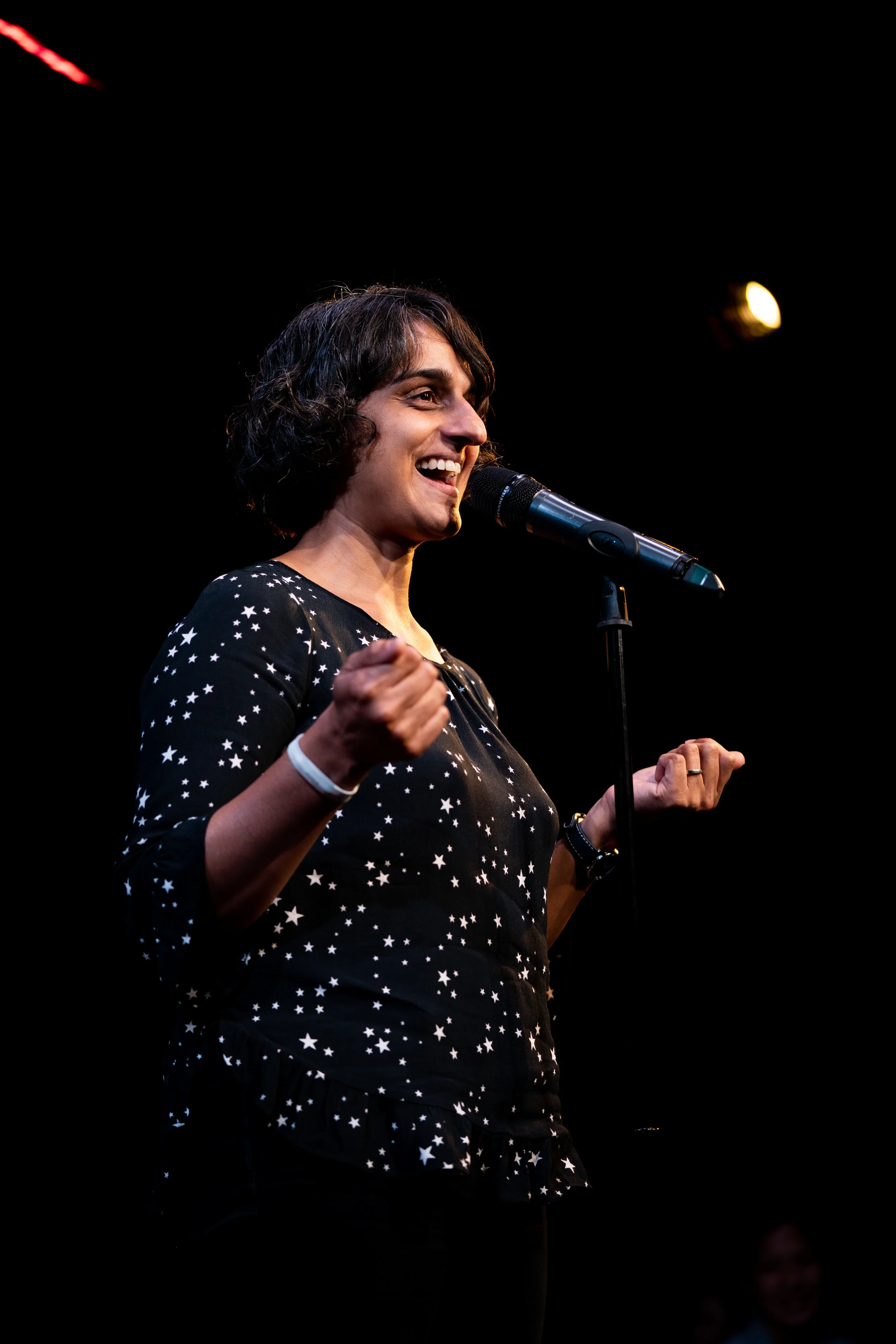 Parmvir Bahia shares her story on The Story Collider stage at Caveat in NYC in October, 2018. The show was presented in partnership with the RockEDU and ASBMB’s SciOut 2018 un-conference. Photo by Zhen Qin.