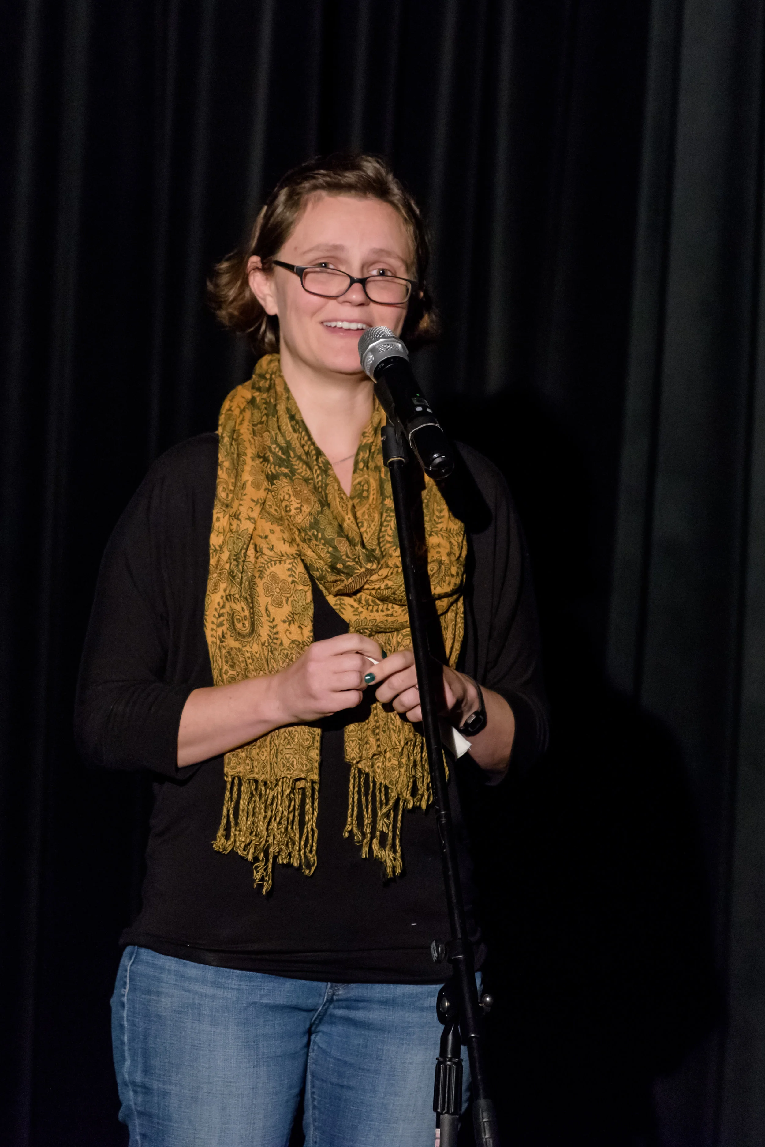 Sarah Hird shares her story on the Story Collider stage at Real Art Ways in Hartford, CT in October 2018. Photo by Nick Caito.