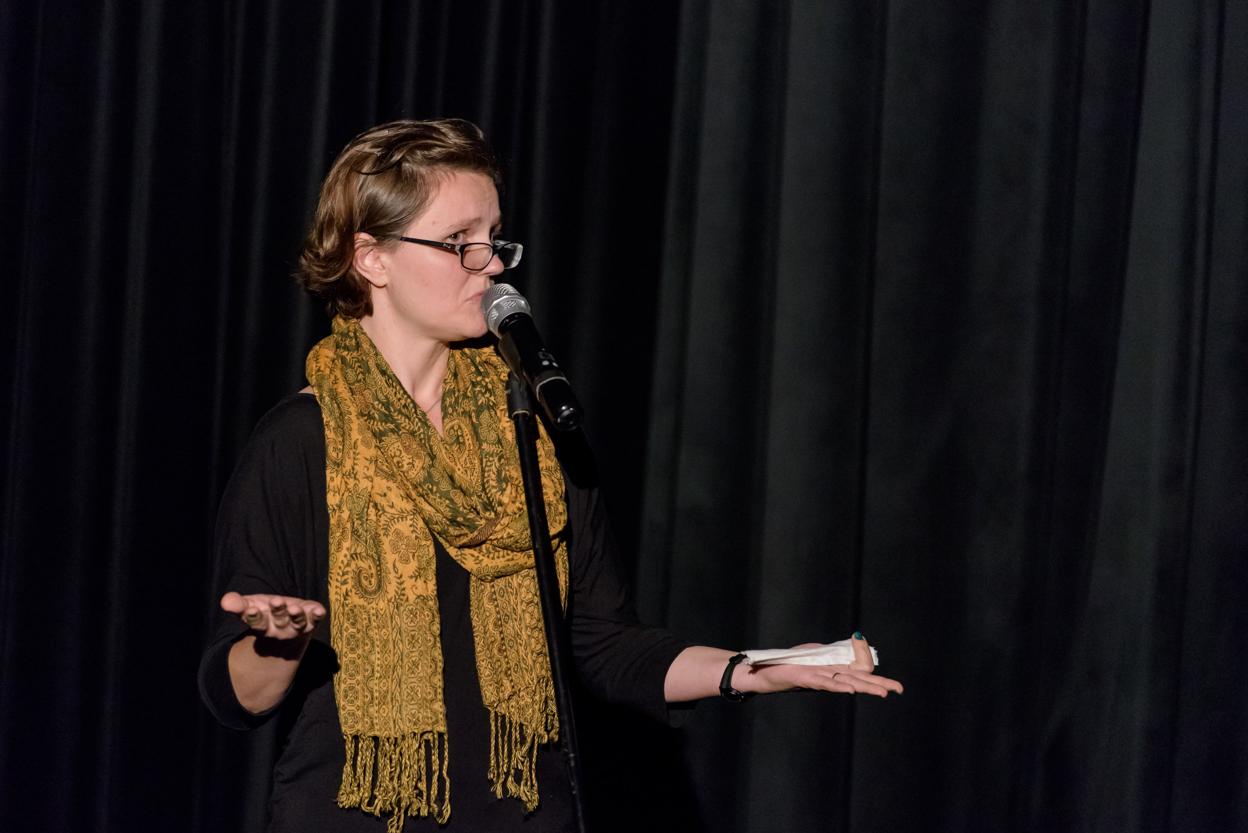 Sarah Hird shares her story on the Story Collider stage at Real Art Ways in Hartford, CT in October 2018. Photo by Nick Caito.
