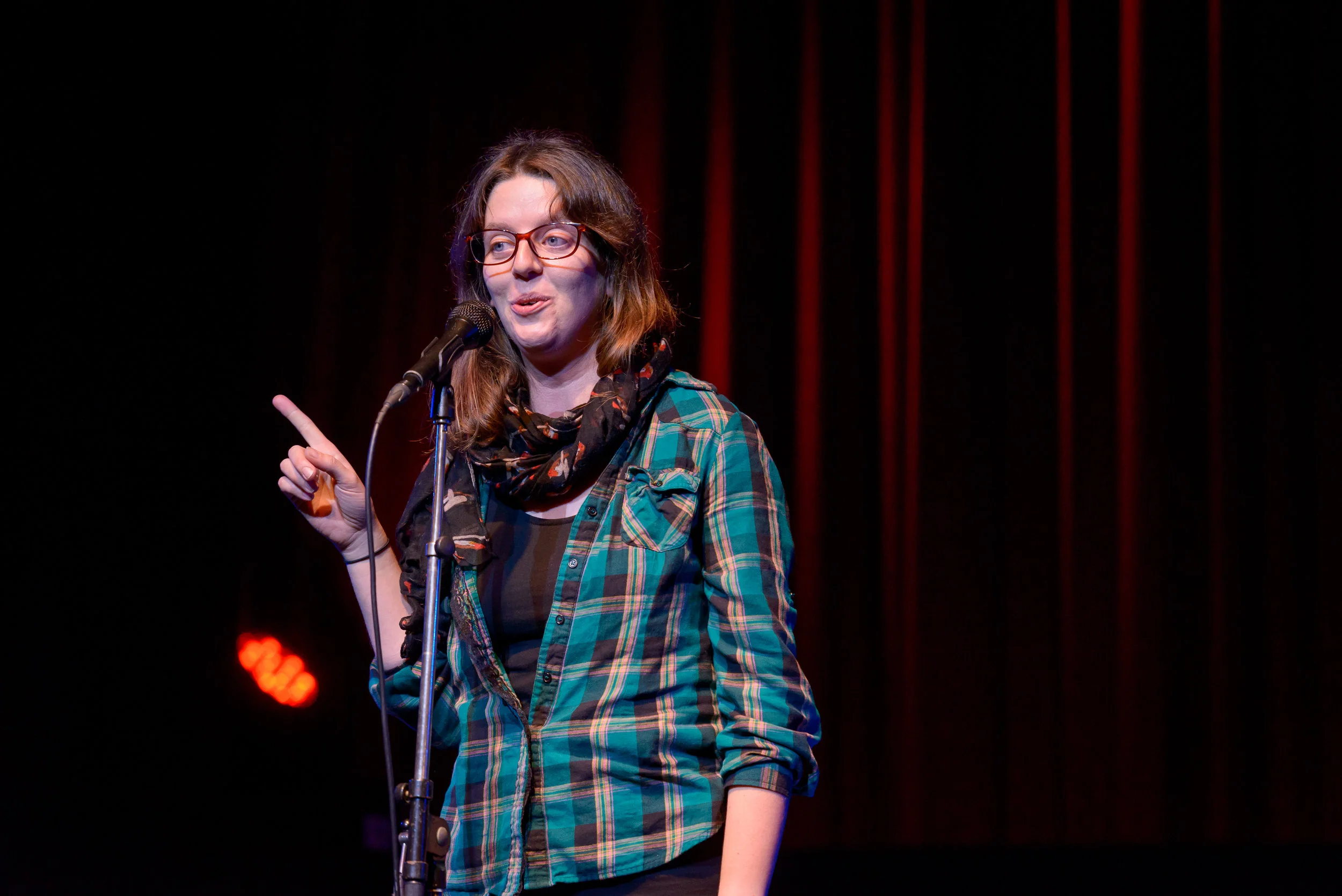 Laura Kehoe shares her story on the Story Collider stage at Fox Cabaret in Vancouver, BC in October 2018. Photo by Rob Shaer.