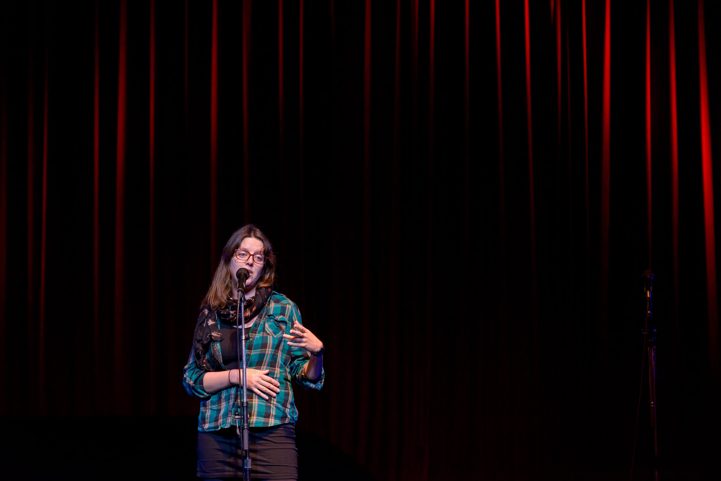 Laura Kehoe shares her story on the Story Collider stage at Fox Cabaret in Vancouver, BC in October 2018. Photo by Rob Shaer.